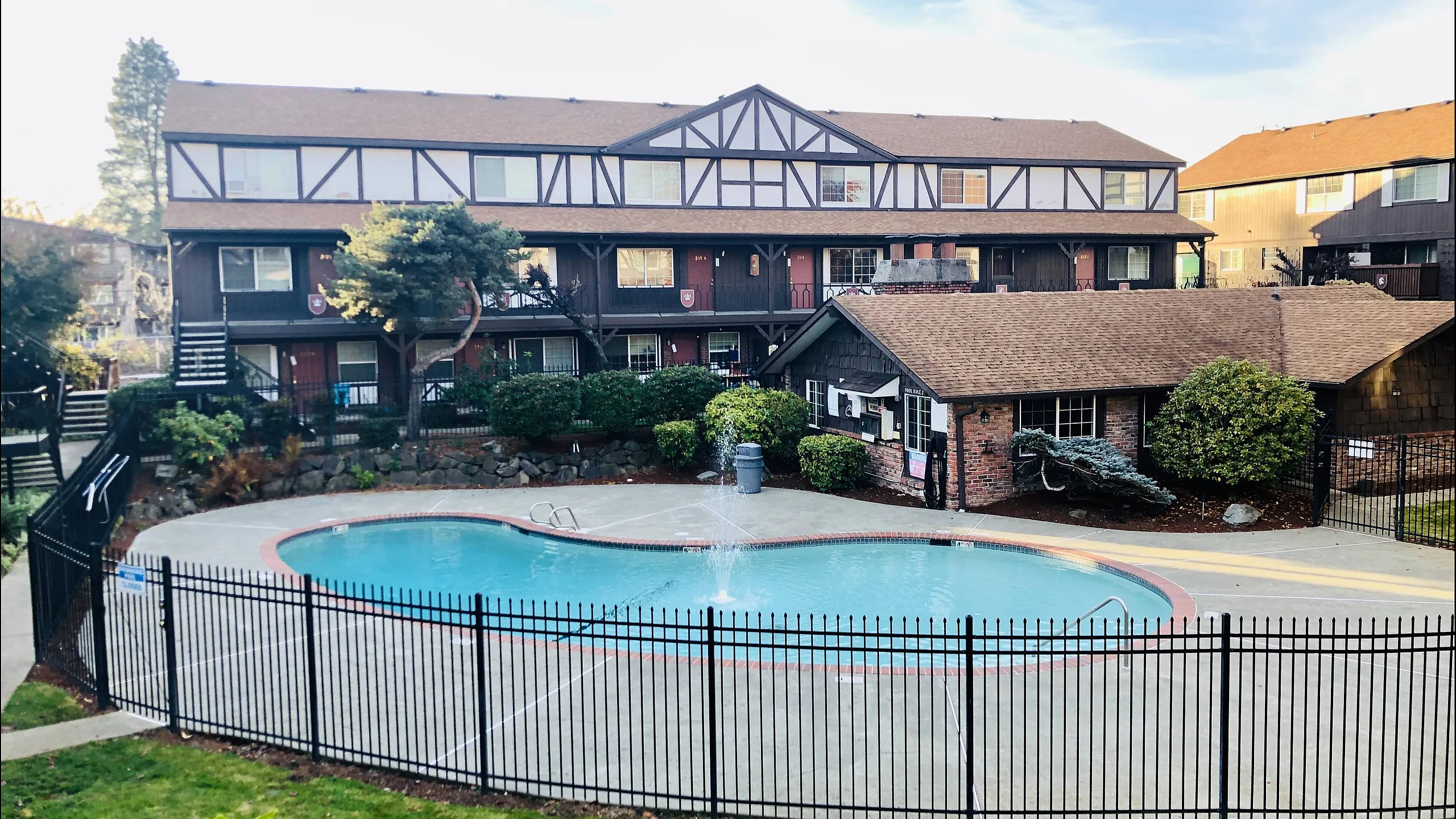sparkiling pool with clubhouse and stylish building