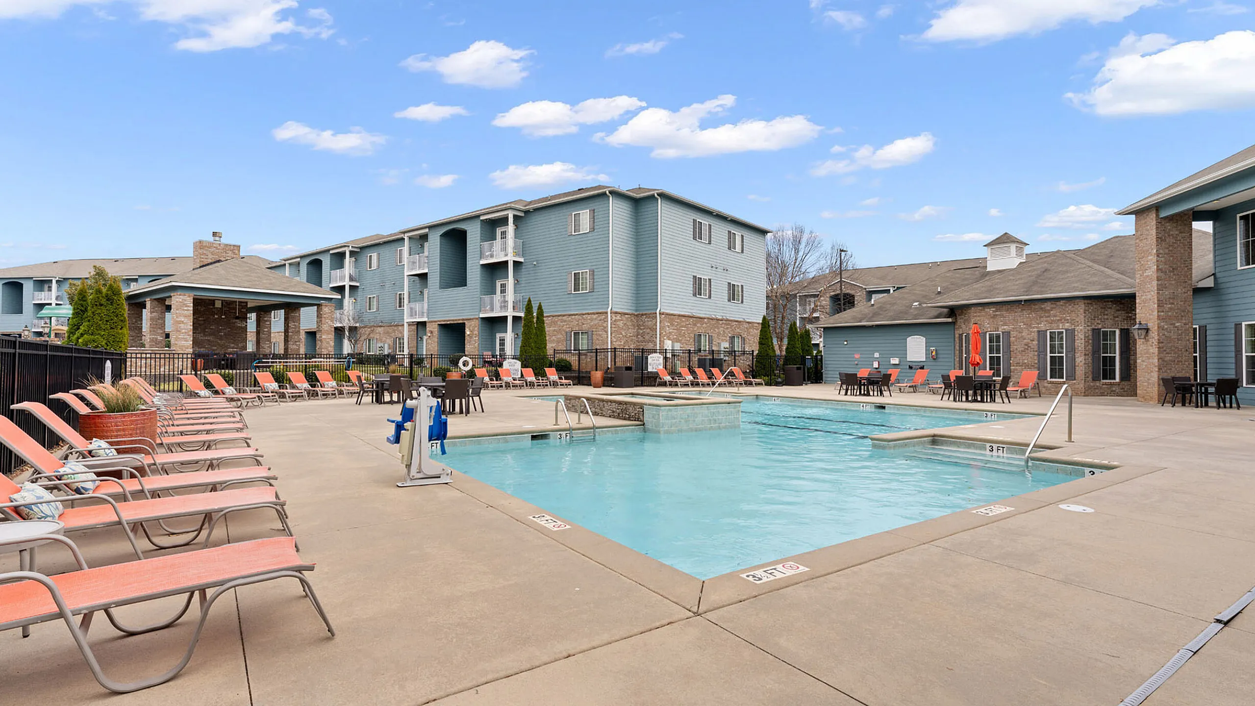 resort style pool with lounge seating and fountain