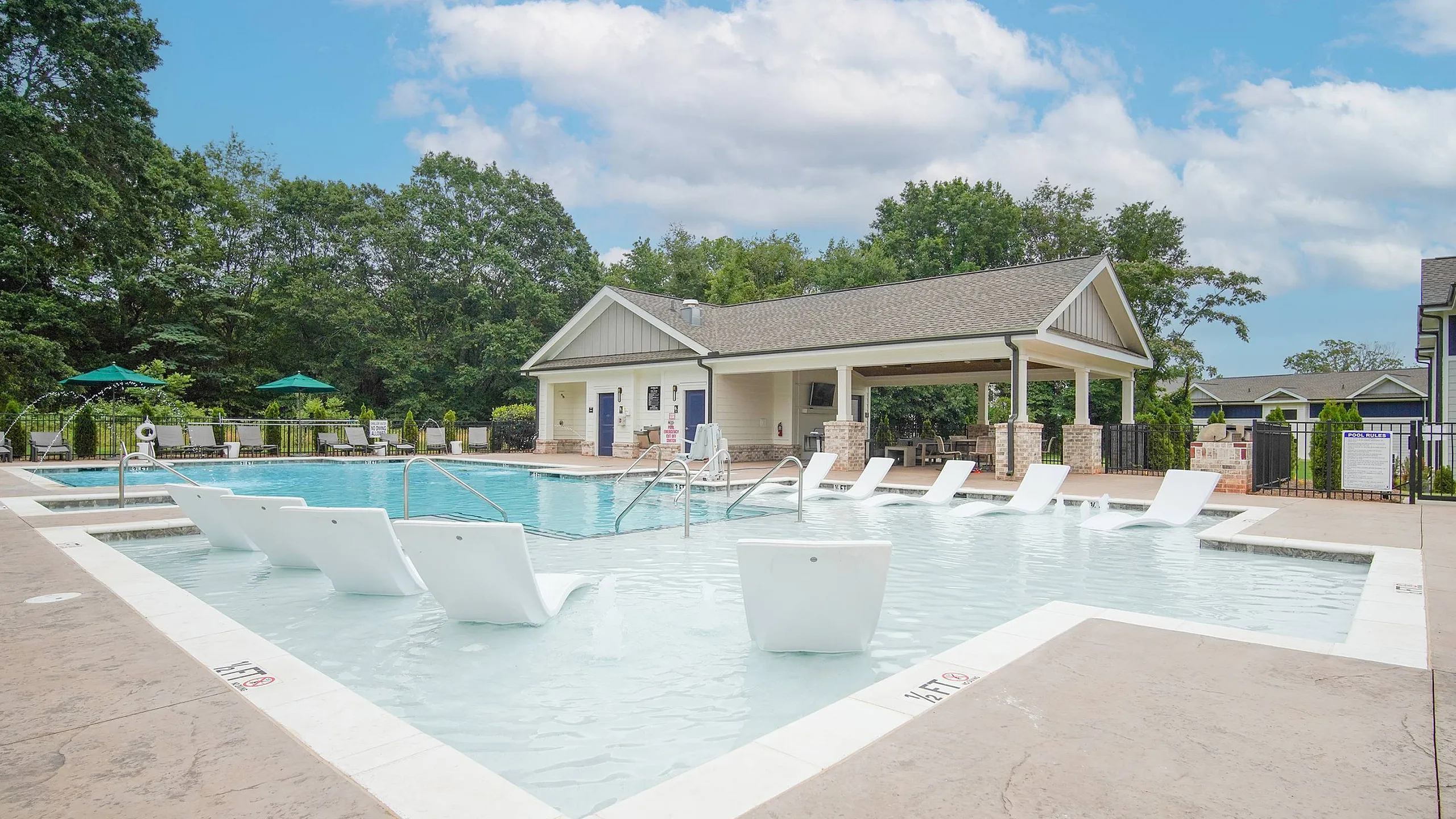 lounge seating in the pool beside the clubhosue and outdoor grill