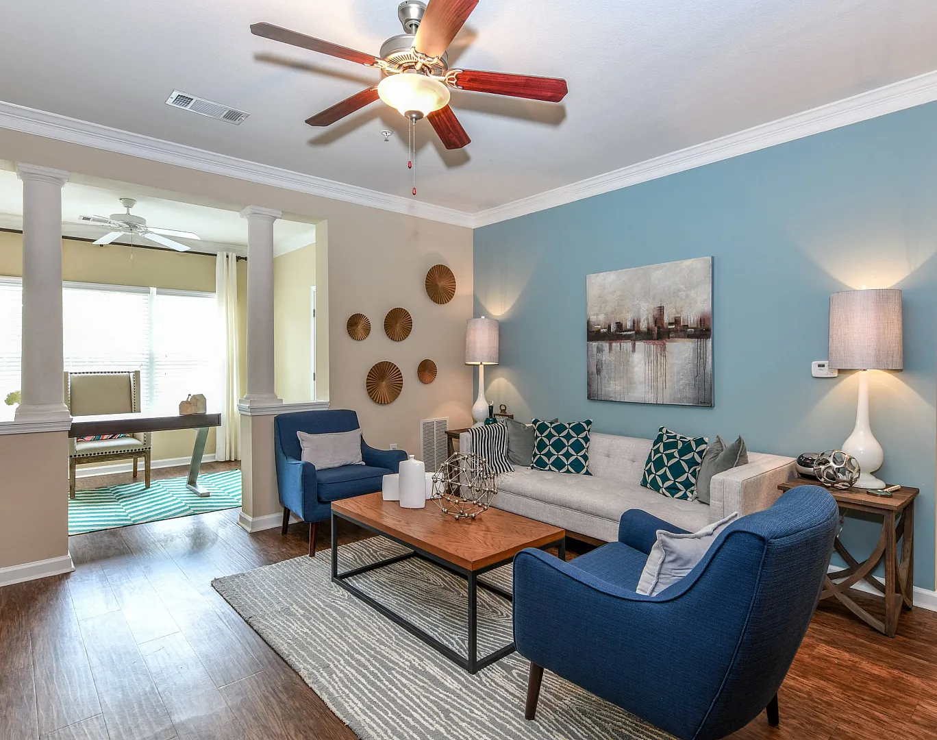 spacious living area with wood style flooring, ceiling fans, open to office and kitchen