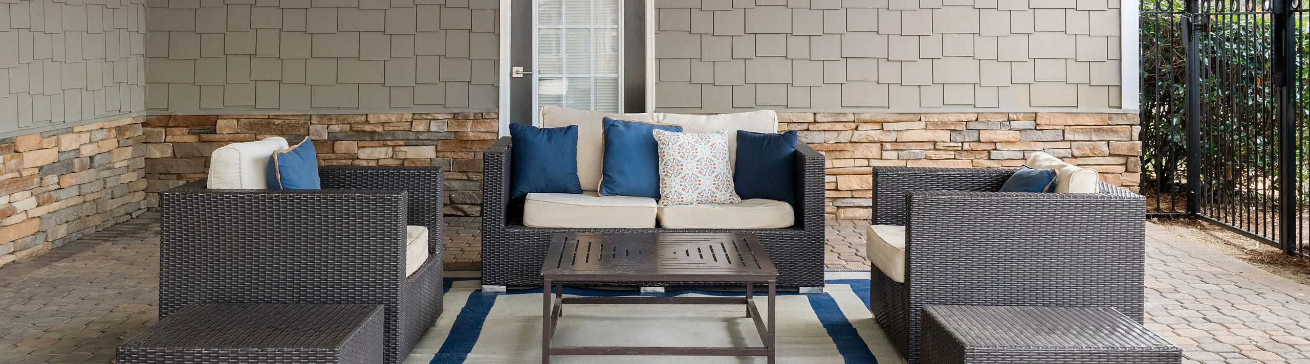 Hangout space on the patio beside the pool and clubhouse