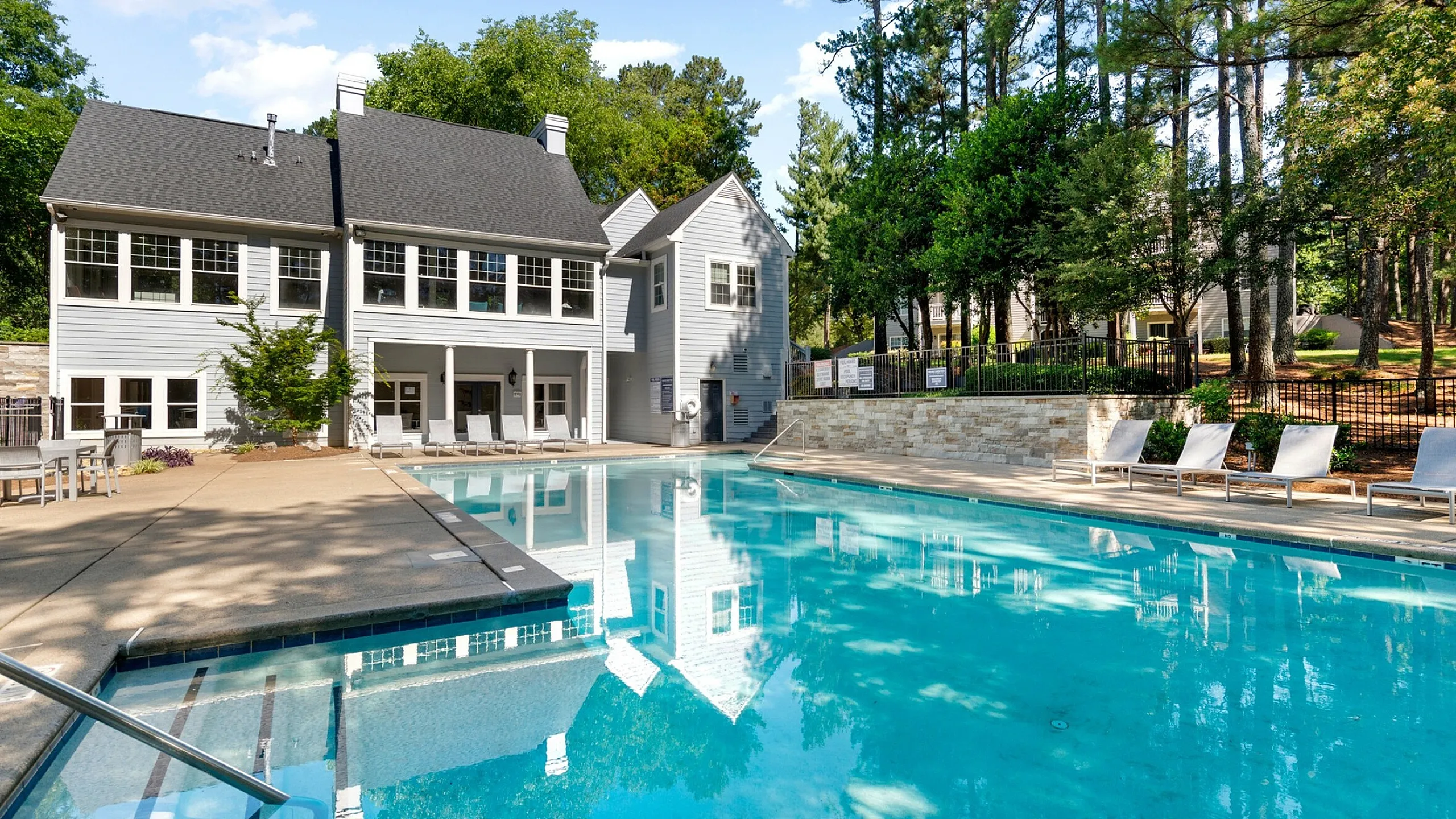 Sparkling pool with clubhouse overlooking