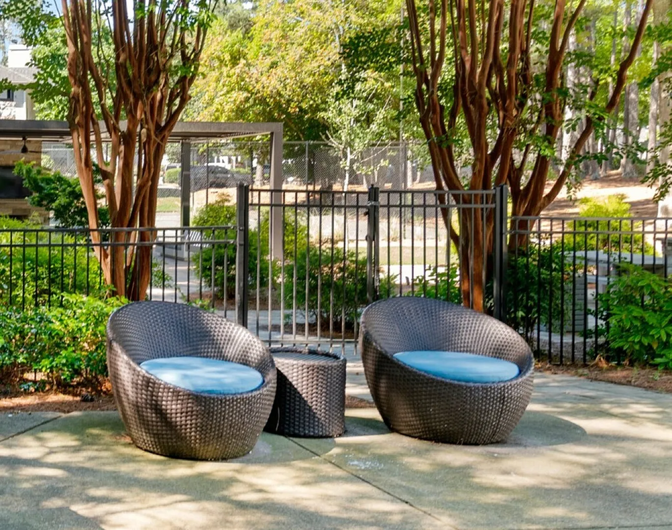 outdoor seating with beautiful landscaping beside the pool