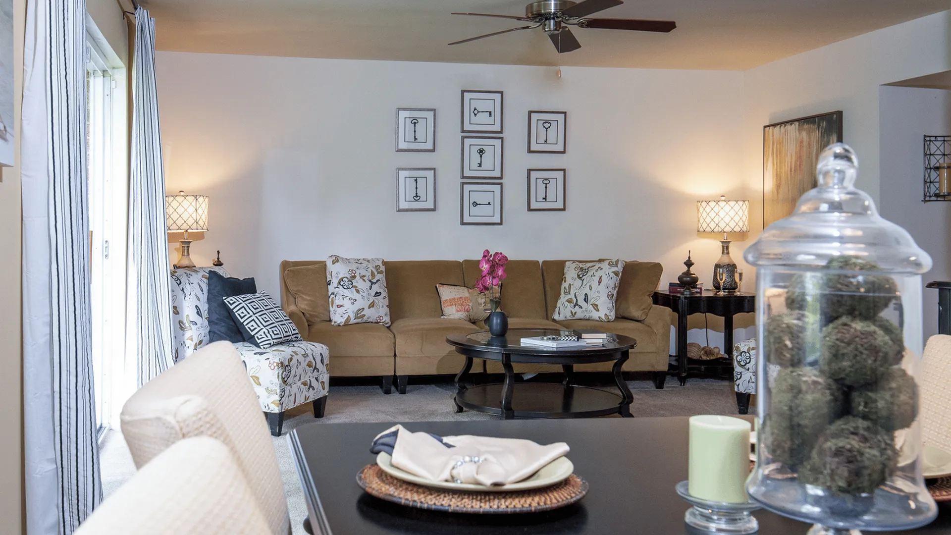 Elegant living room with a cozy beige sectional, stylish decor, and soft ambient lighting perfect for relaxation.