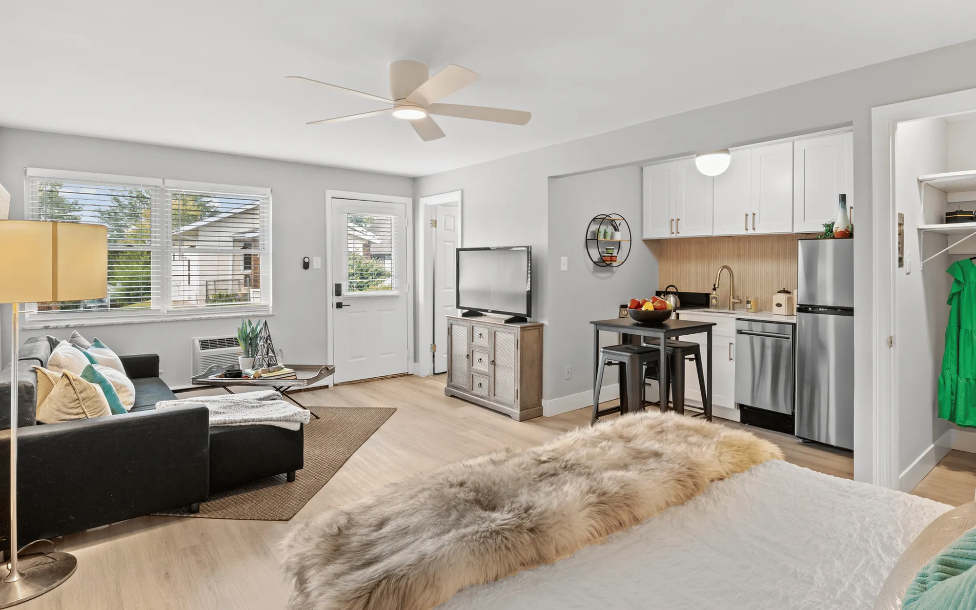 Bright and cozy studio apartment with modern furniture, open layout, and large windows.
