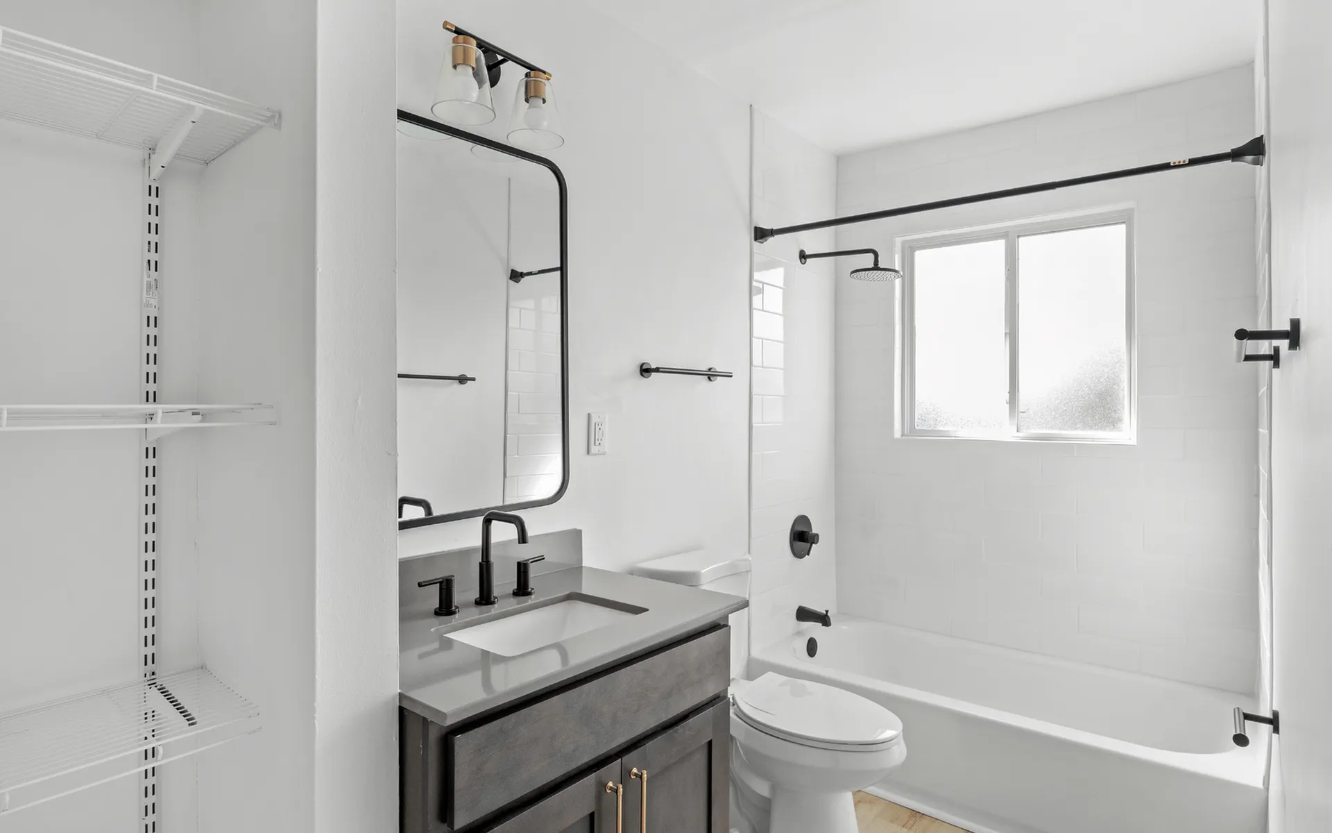 Modern and elegant bathroom with sleek fixtures, spacious bathtub, and bright natural lighting, perfect for relaxation.