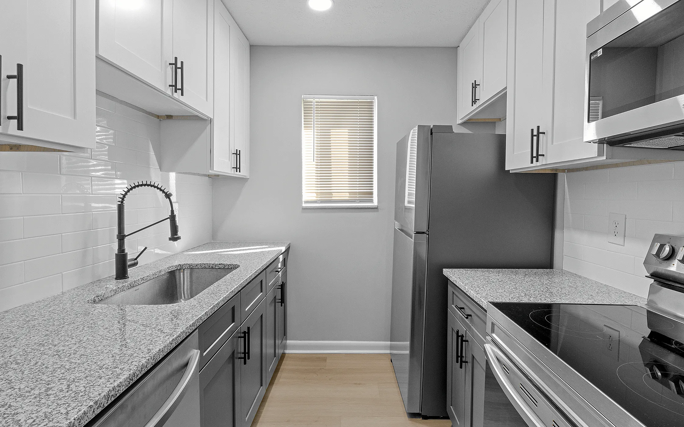 Chic modern kitchen with sleek granite countertops, stylish cabinetry, and stainless steel appliances.