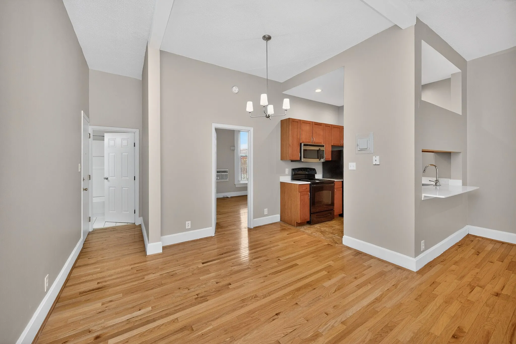 Bright modern apartment with open layout, hardwood floors, and contemporary kitchen design.