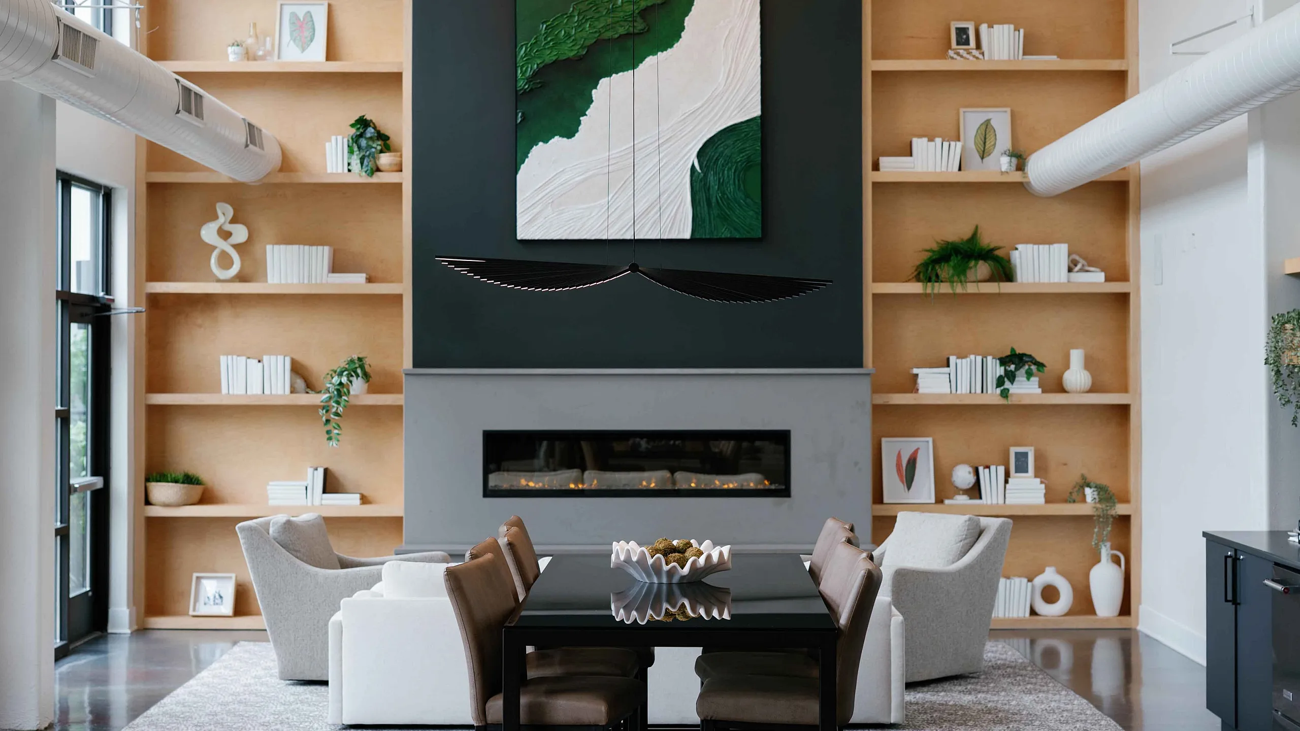 Stylish resident clubhouse at The Ave Apartments in Clintonville, Columbus, OH with cozy seating, fireplace, and contemporary design.