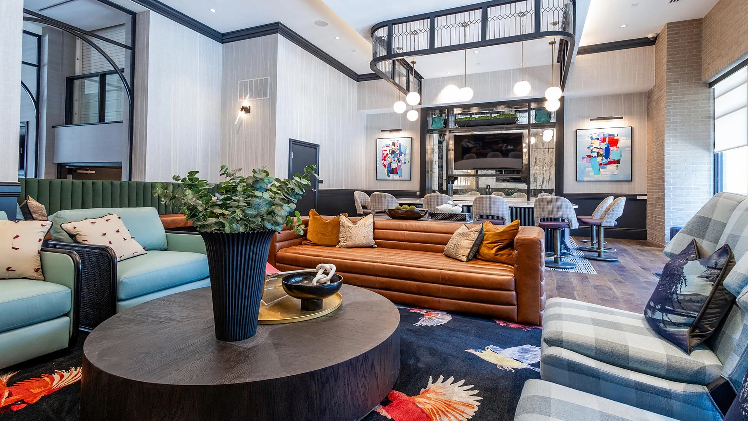 Luxurious contemporary living room featuring stylish seating, modern decor, and elegant lighting, perfect for relaxation and entertainment. Woodburn Exchange Apartments in East Walnut Hills.