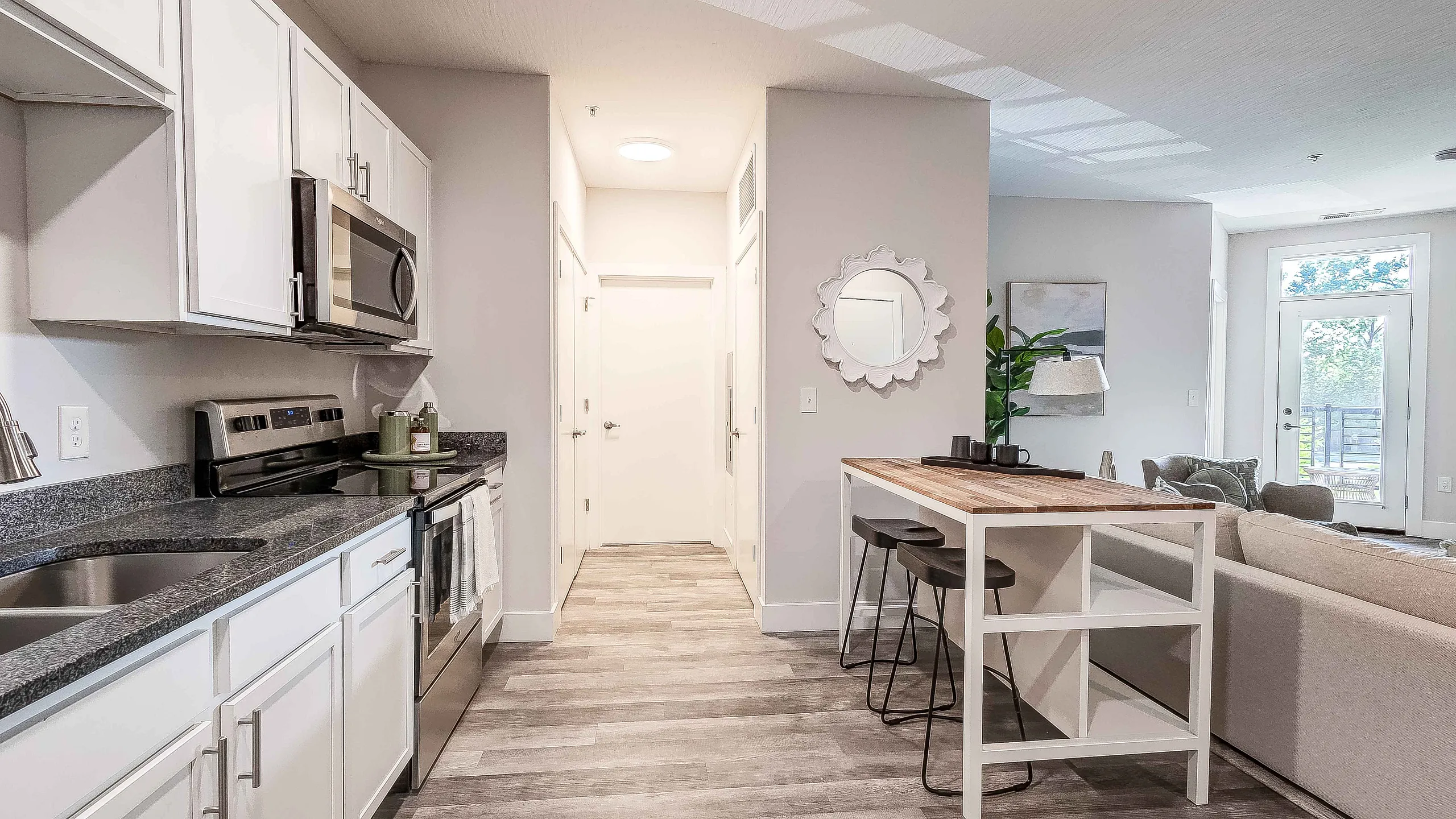 Modern open-concept kitchen with sleek appliances, stylish countertops, and a cozy living area perfect for entertaining.