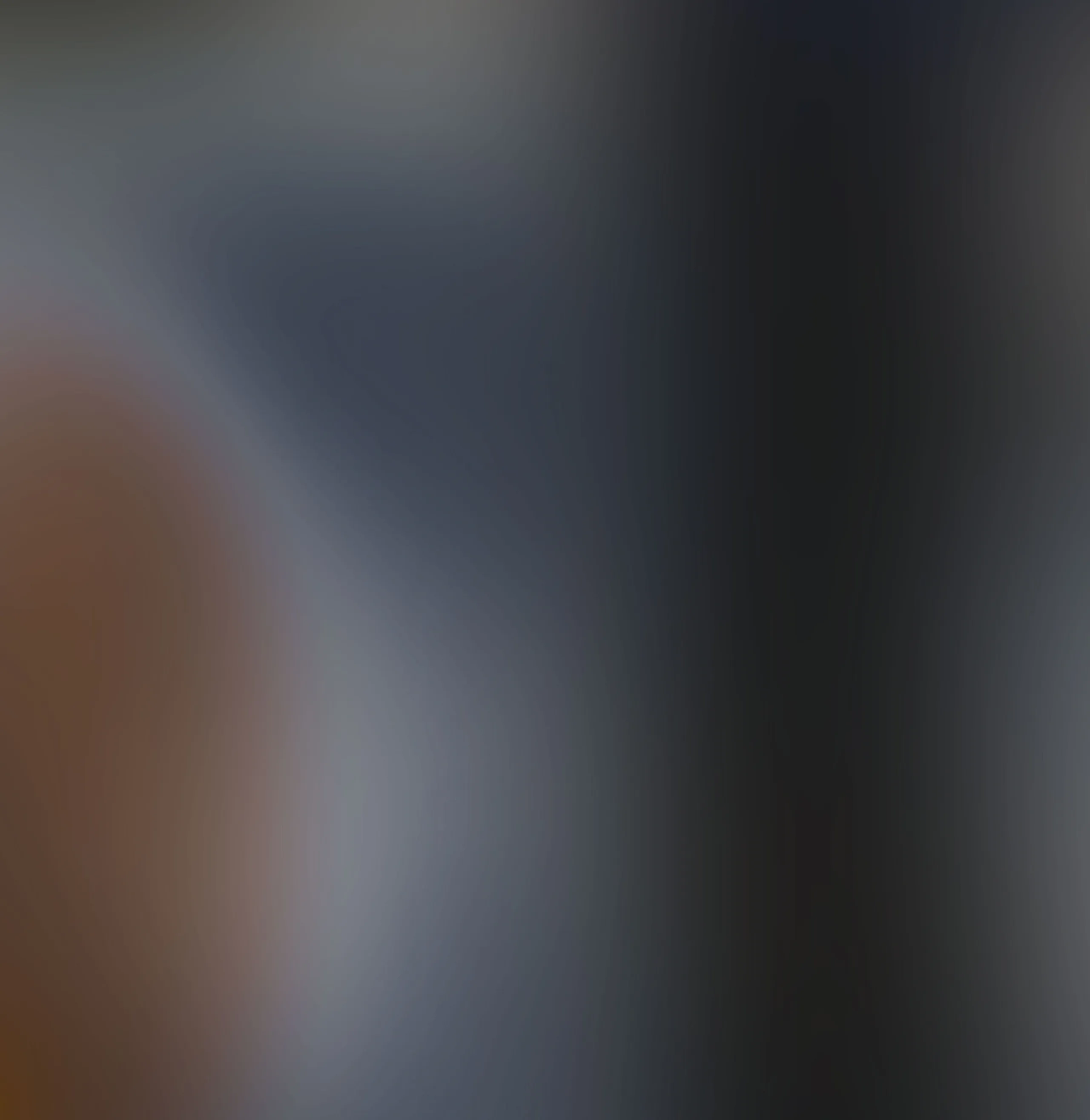 Blurred transparent colorful background with dark blue, grey, and rust orange.