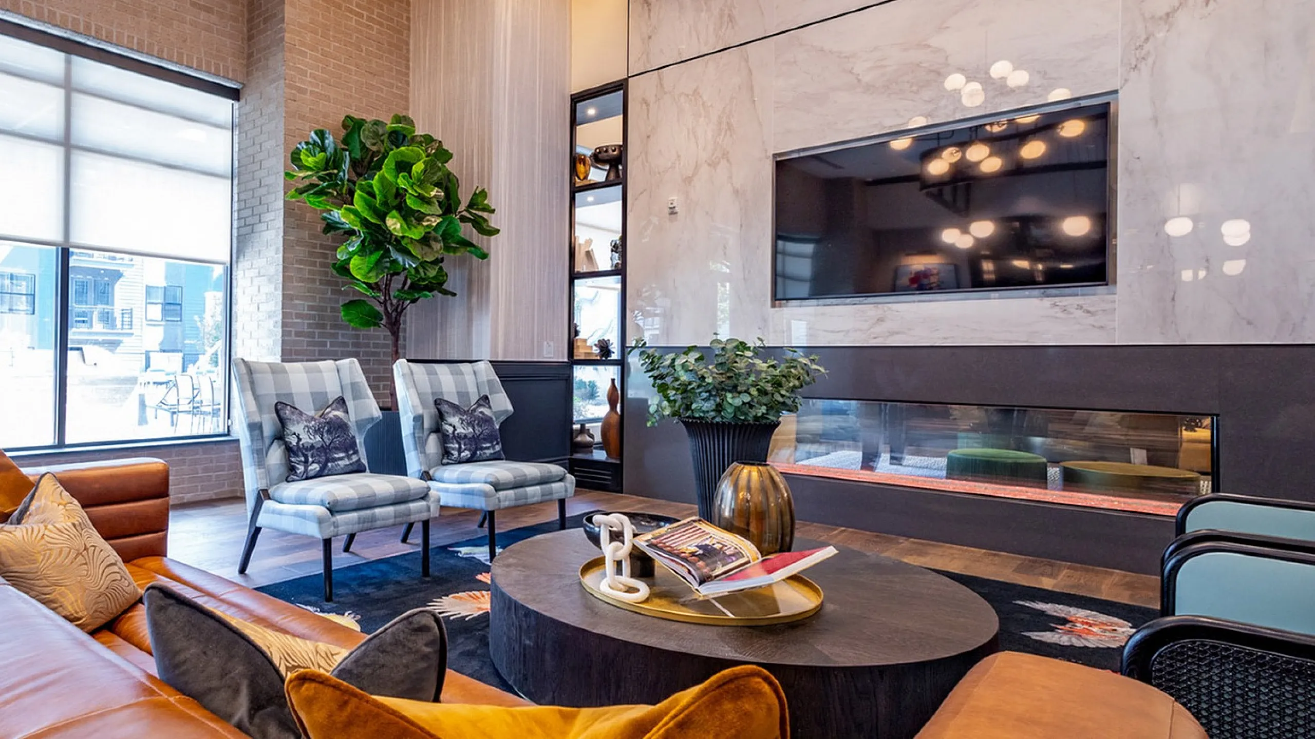 Chic and modern living room with elegant leather sofas, plush pillows, and a stylish fireplace, perfect for relaxation and entertainment.