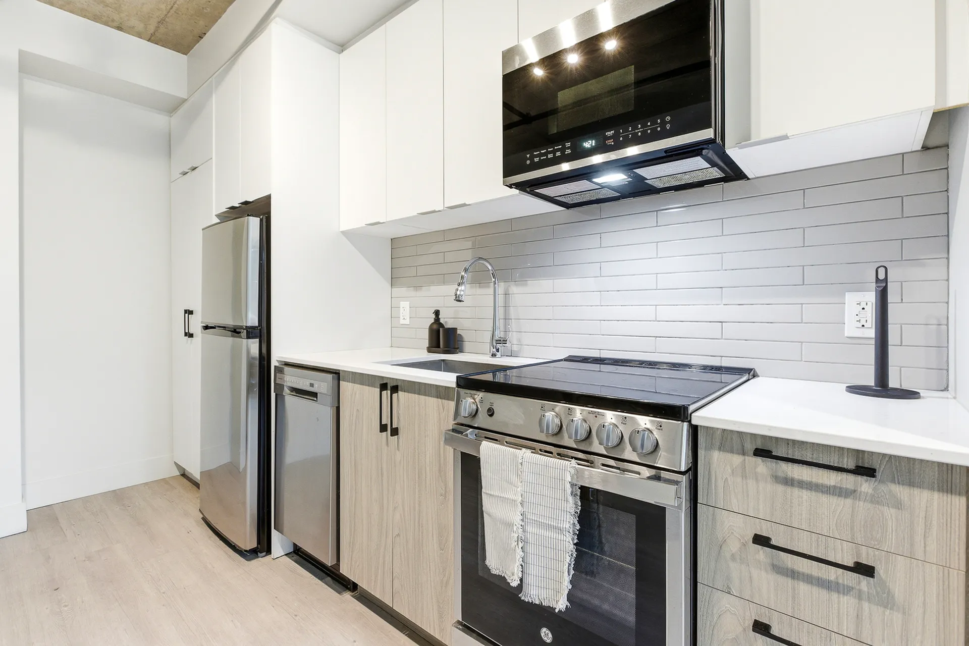 Modern kitchen with sleek stainless steel appliances, stylish cabinetry, and a contemporary design.