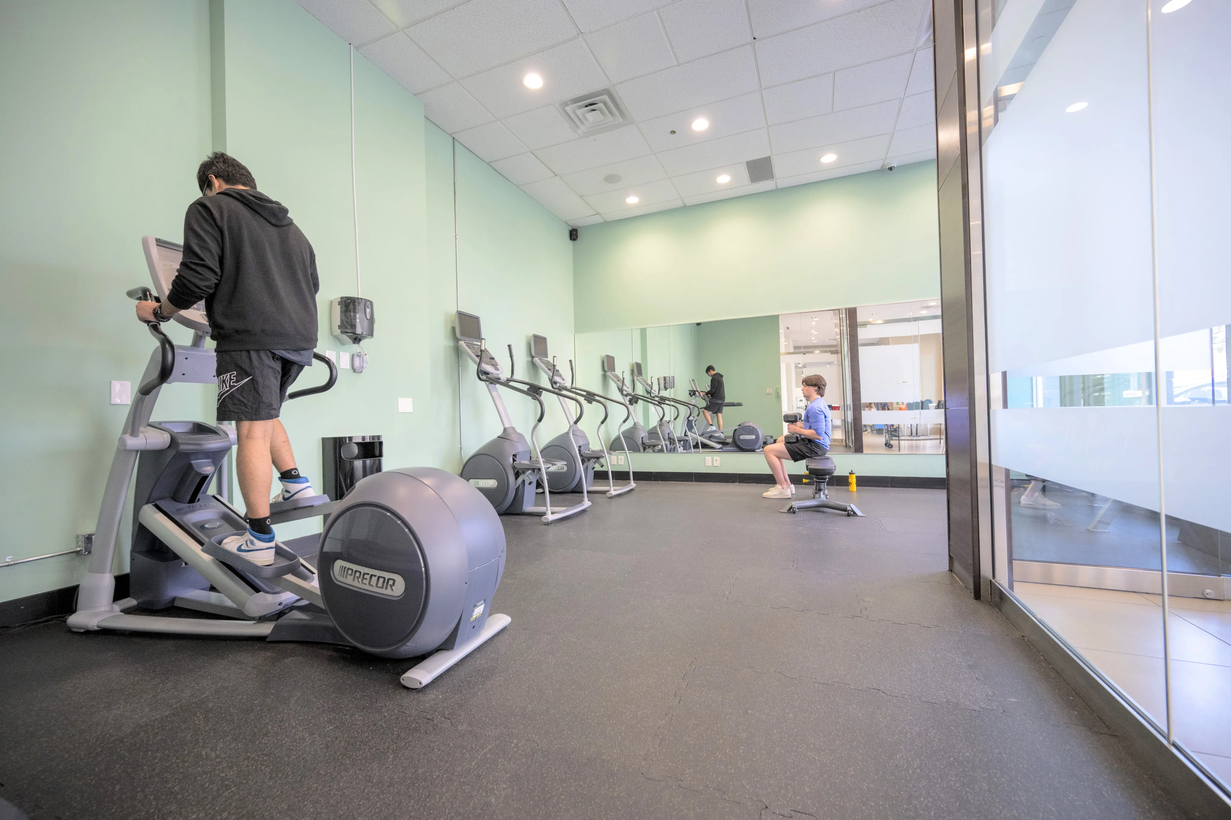 Modern fitness center with state-of-the-art equipment and mirrored walls, perfect for an energetic workout.