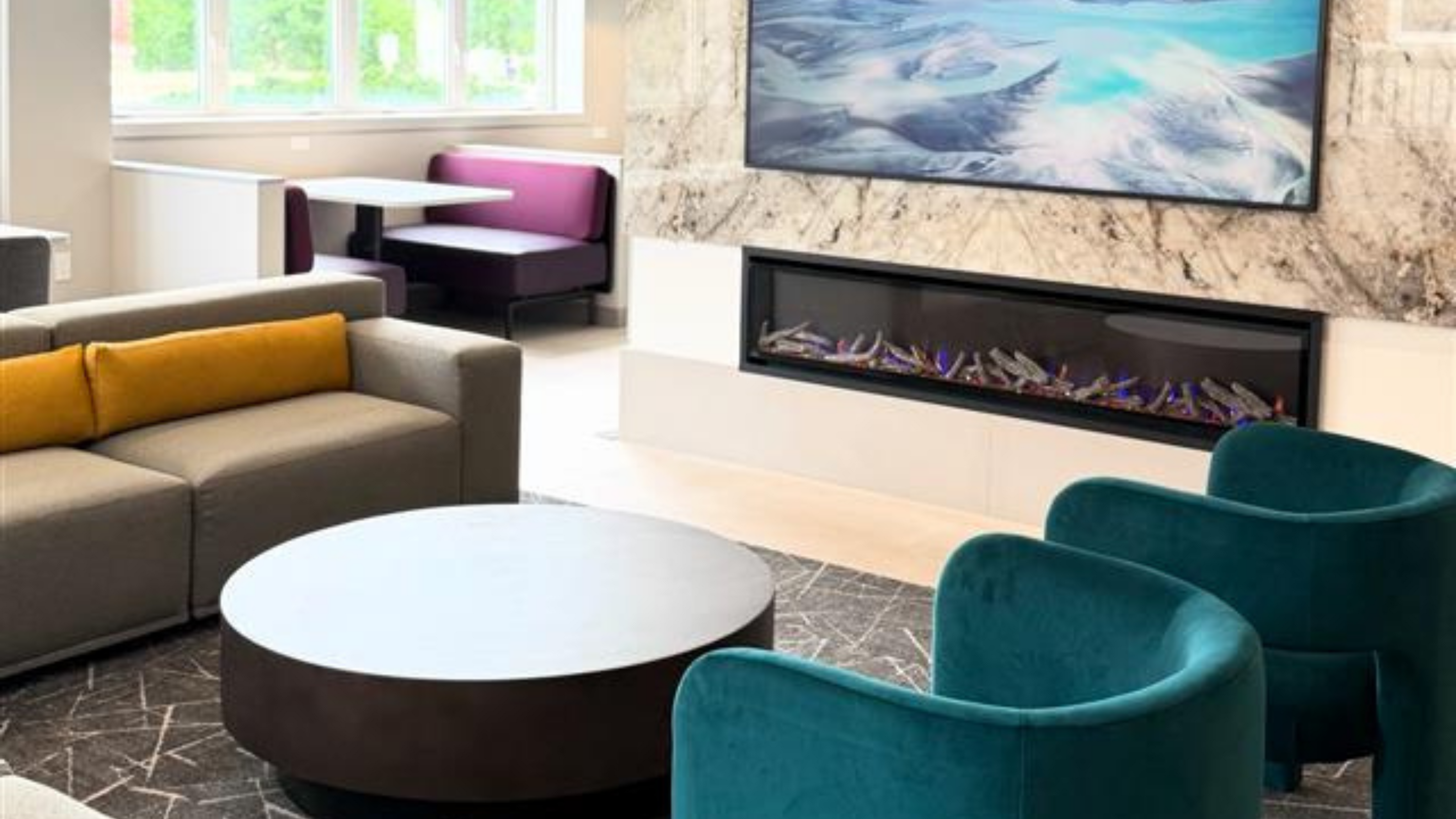 Contemporary living room with elegant seating, modern fireplace, and vibrant decor for a stylish urban retreat.