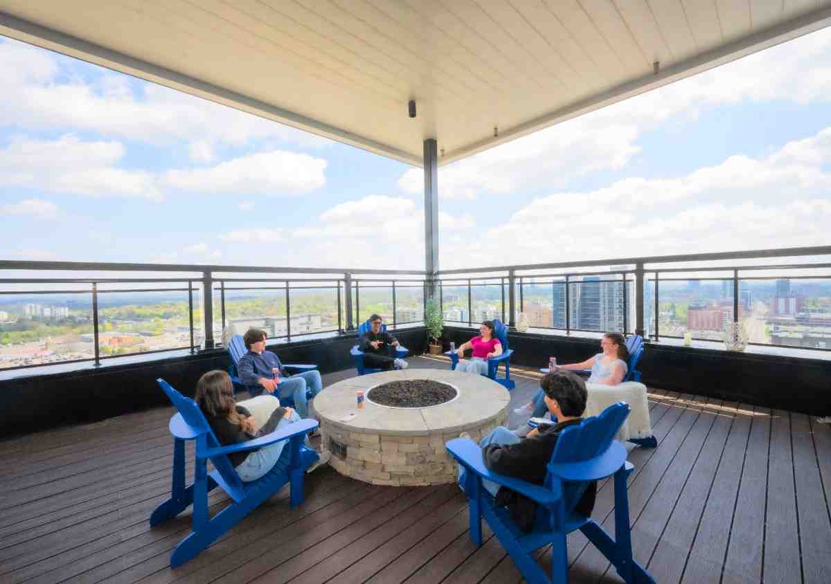 Stunning rooftop patio with breathtaking city views and cozy seating around a modern fire pit.