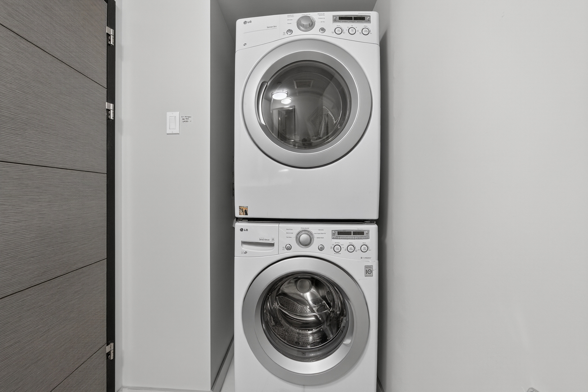 Modern apartment laundry area with a sleek stacked washer and dryer, maximizing space efficiency and style.