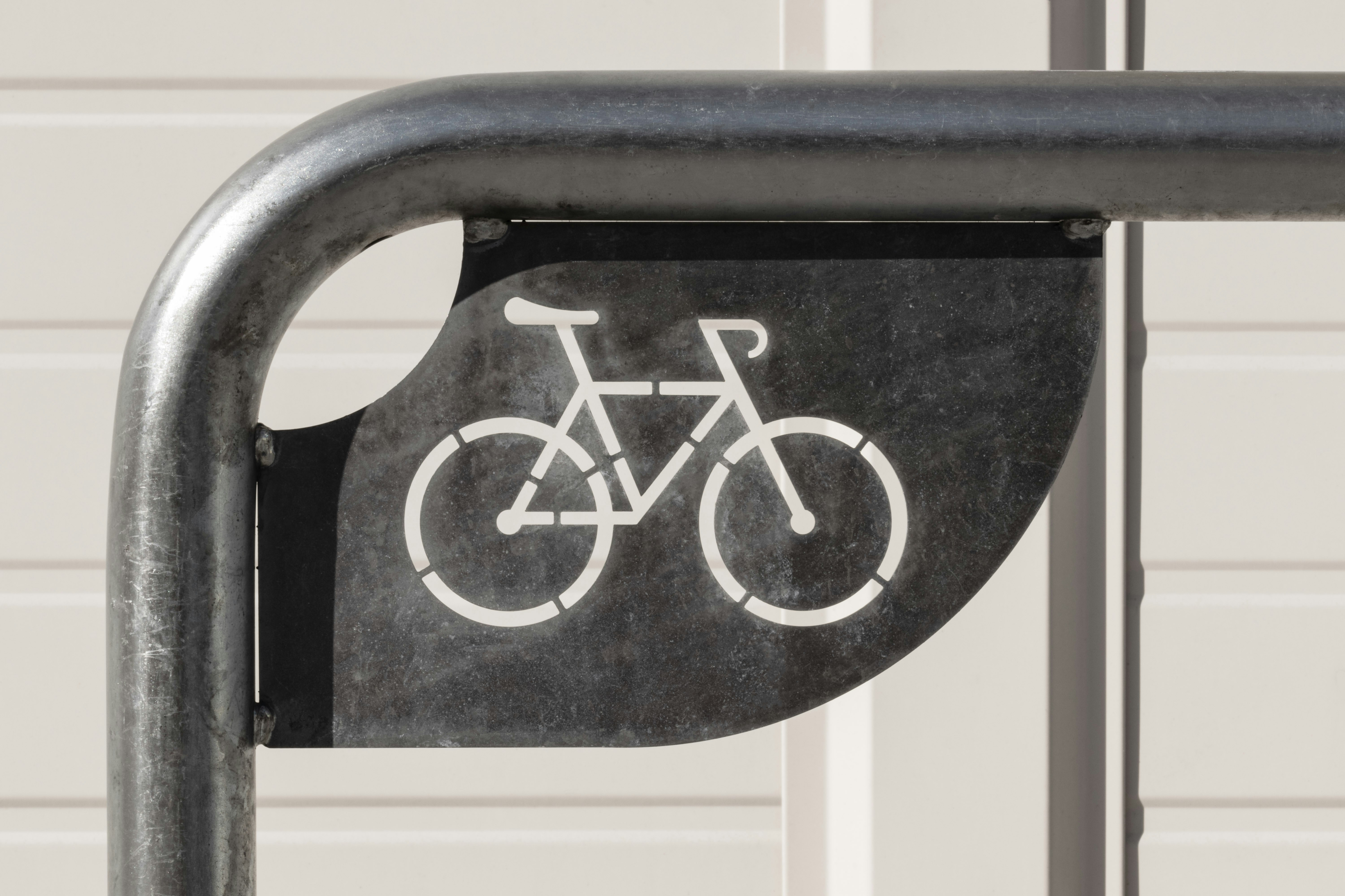 Sleek urban bike rack with a stylish bicycle cutout design, perfect for modern eco-friendly apartments.