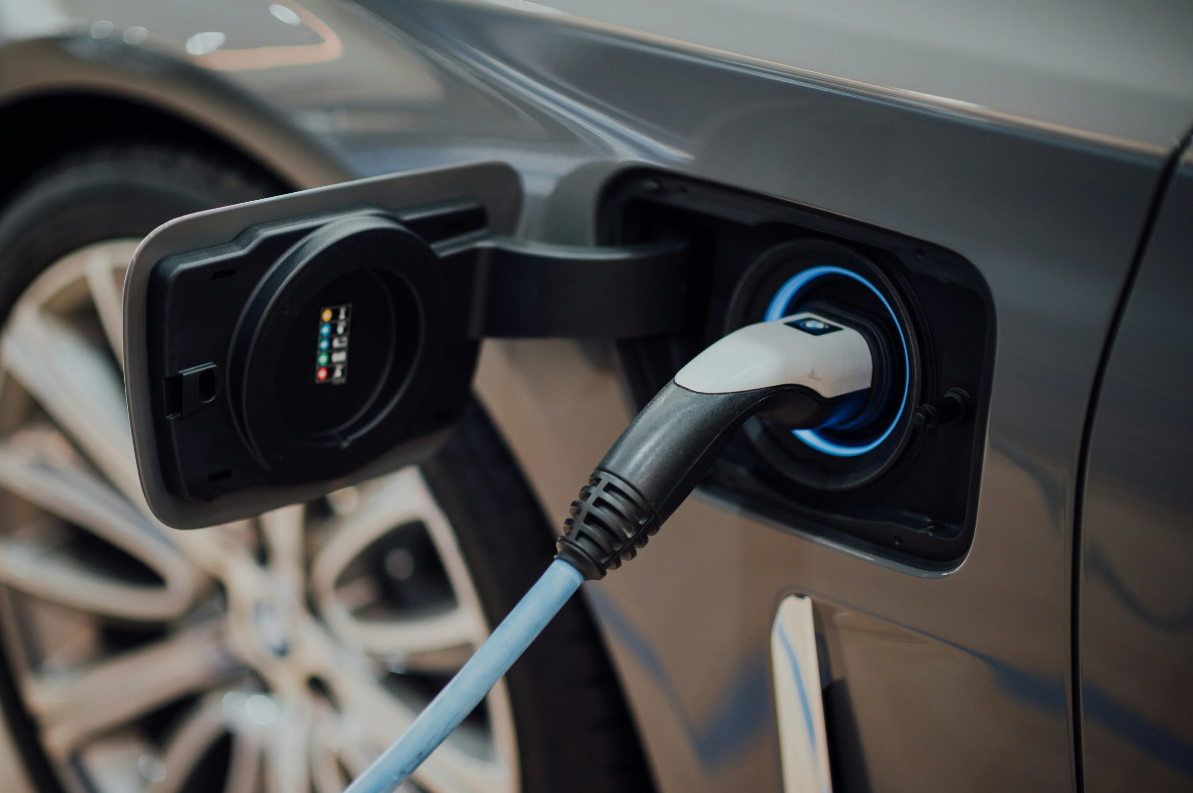 Close-up of an electric car charging, showcasing sleek design and advanced technology.