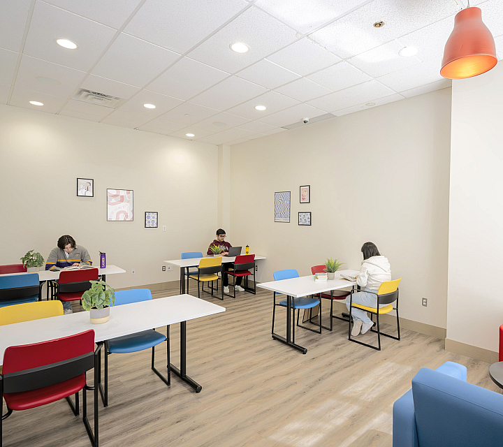 Bright, modern study room with vibrant chairs and natural light, perfect for focused work and creativity.