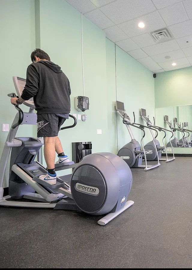 Modern fitness center with state-of-the-art exercise equipment and spacious workout area, promoting a healthy lifestyle.