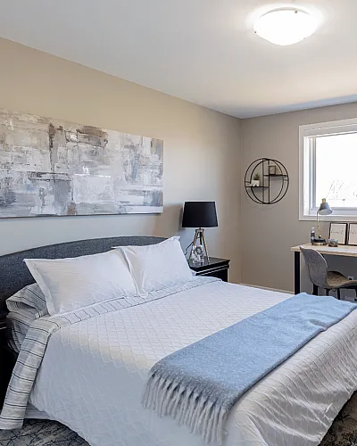 Inviting bedroom with stylish decor, natural light, and elegant furnishings, perfect for relaxation.