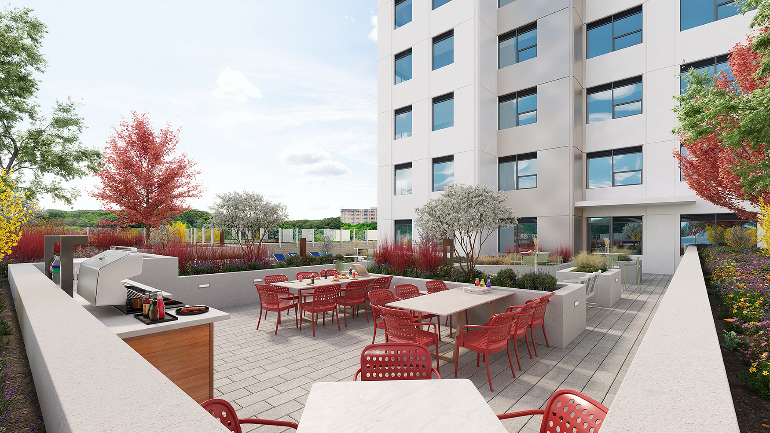 Chic outdoor terrace with vibrant red chairs, modern barbecue area, and lush garden setting in a contemporary apartment complex.