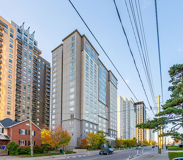 Chic urban high-rise apartments with sleek architecture and vibrant street views, perfect for modern living.
