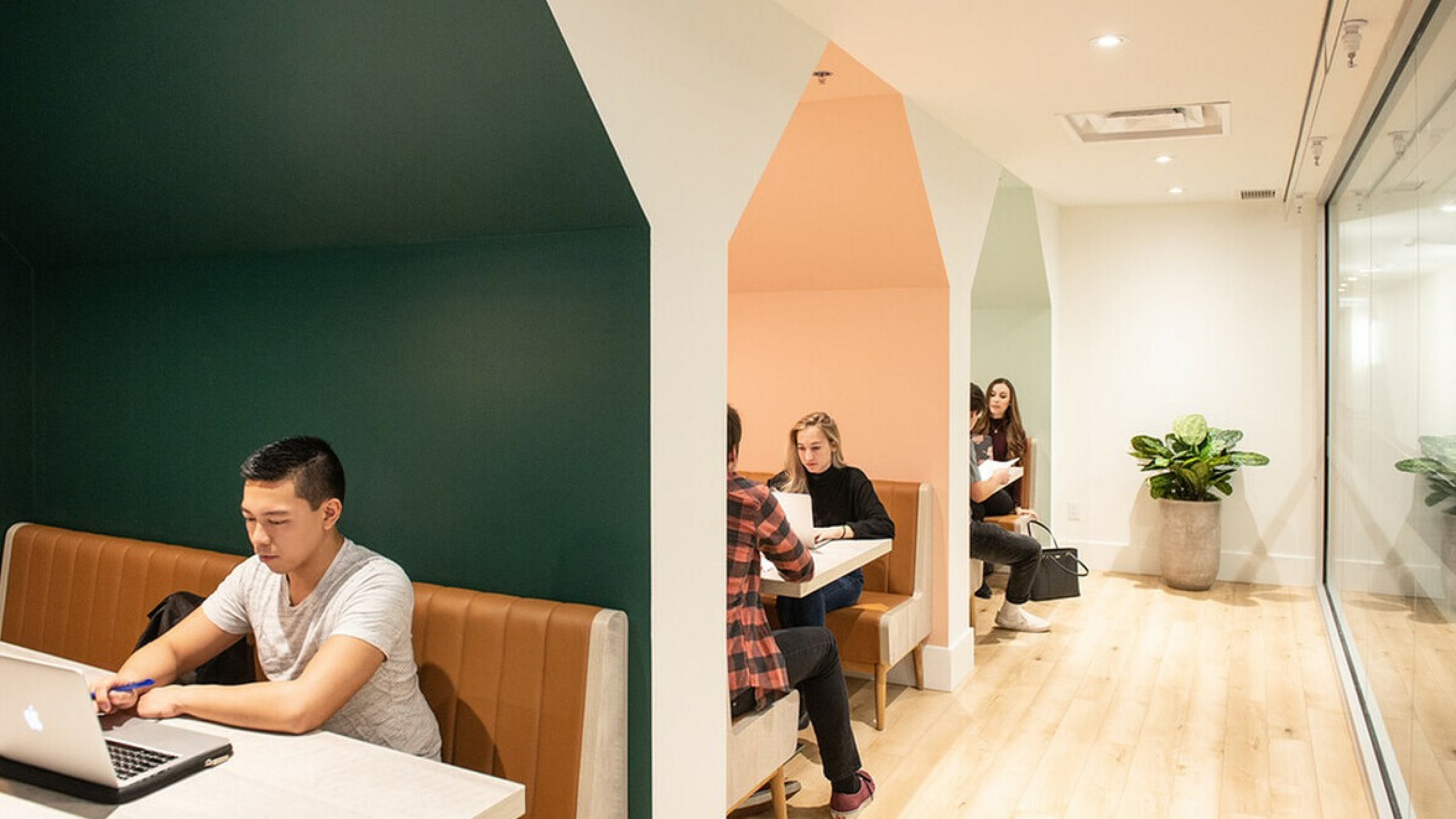 Chic modern workspace with cozy booths providing an inviting atmosphere, ideal for focused work and collaboration.