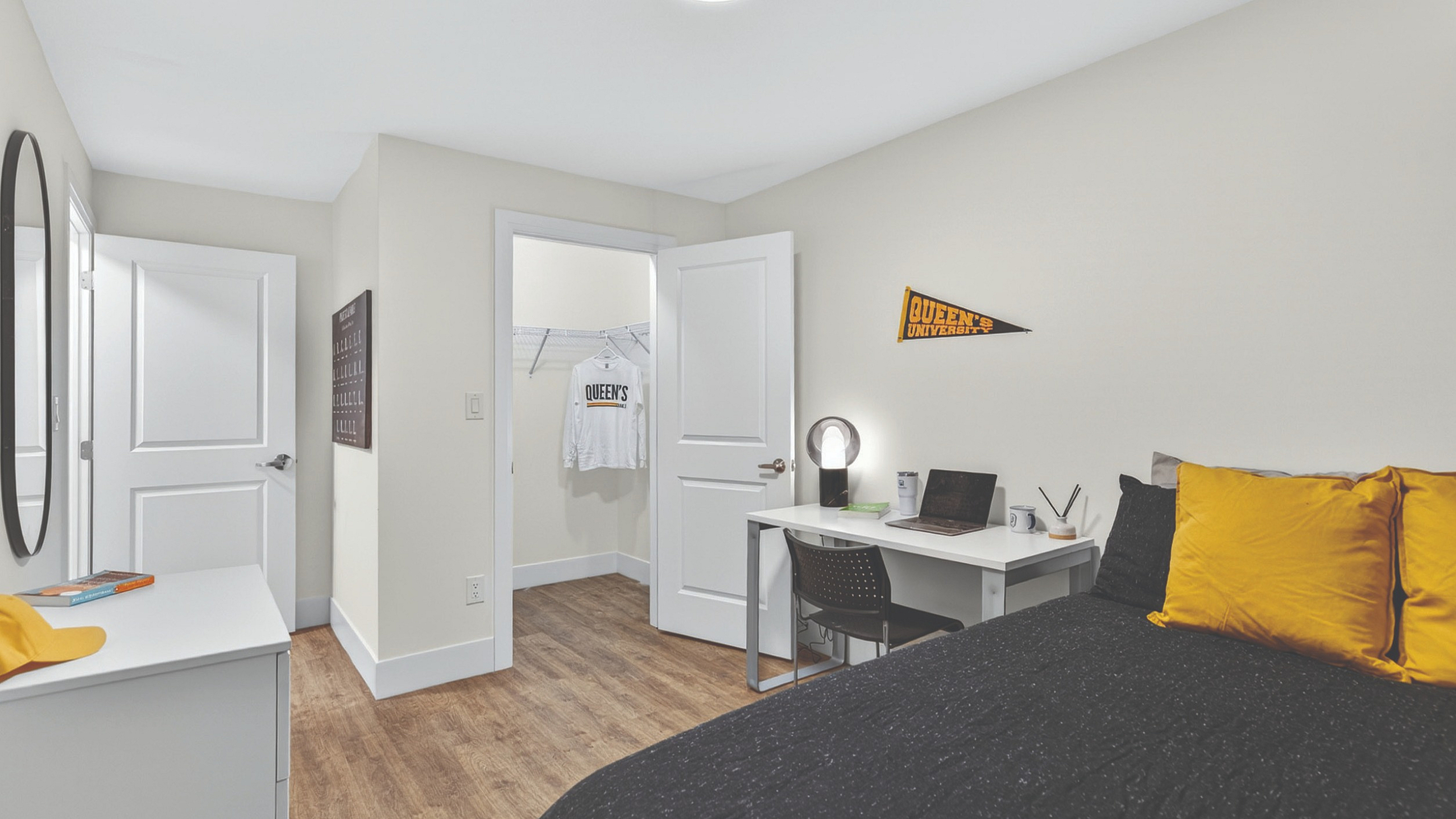 Cozy bedroom with modern design featuring a comfortable bed, study desk, and inviting natural light.