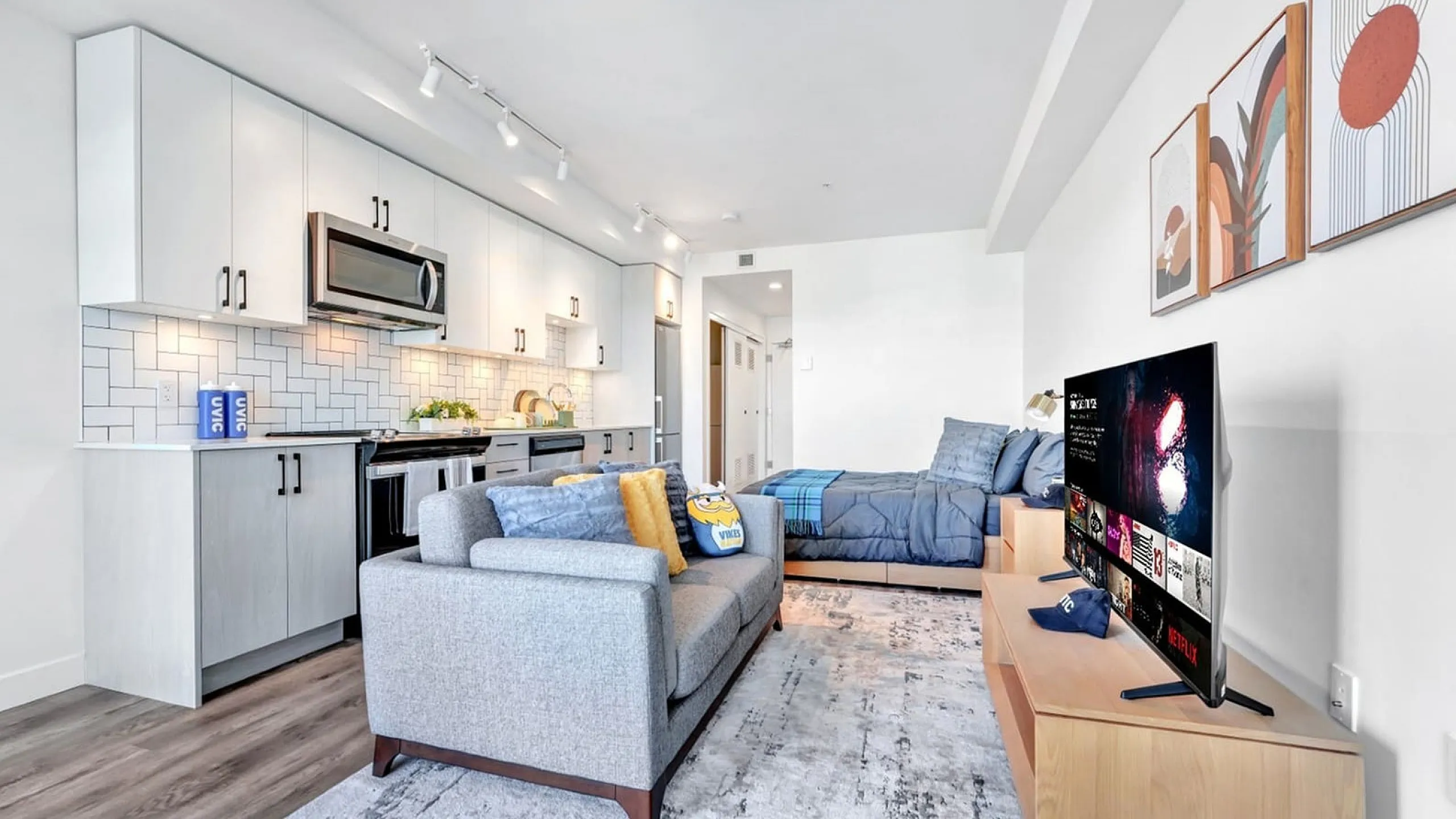 Modern studio apartment interior with sleek kitchen, cozy living area, and stylish decor.