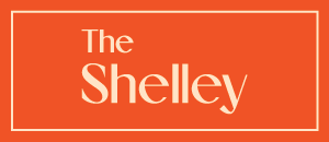 Bold and modern logo showcasing The Shelley in elegant typography against a vibrant orange background.