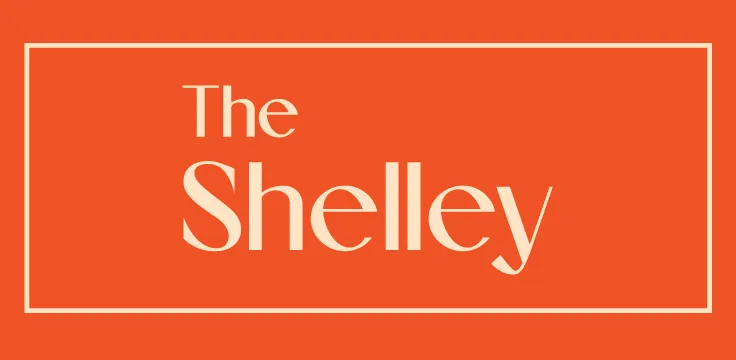 Vibrant orange logo for The Shelley, featuring elegant typography within a bold frame.