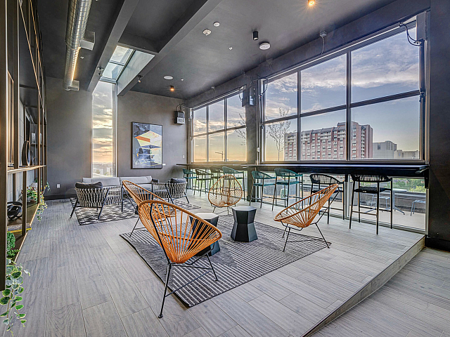 Rooftop lounge at 6th and Main with city views and seating areas