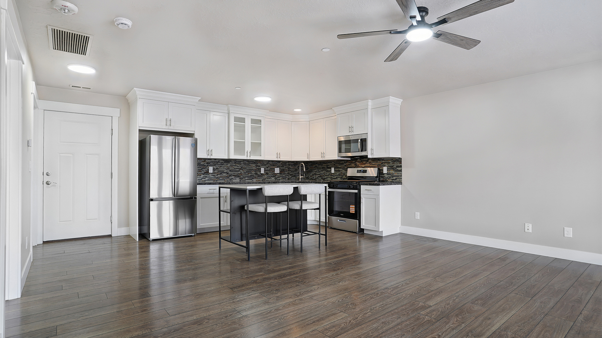 Modern apartment interior at Junction View featuring open layout, balcony access, and updated finishes.