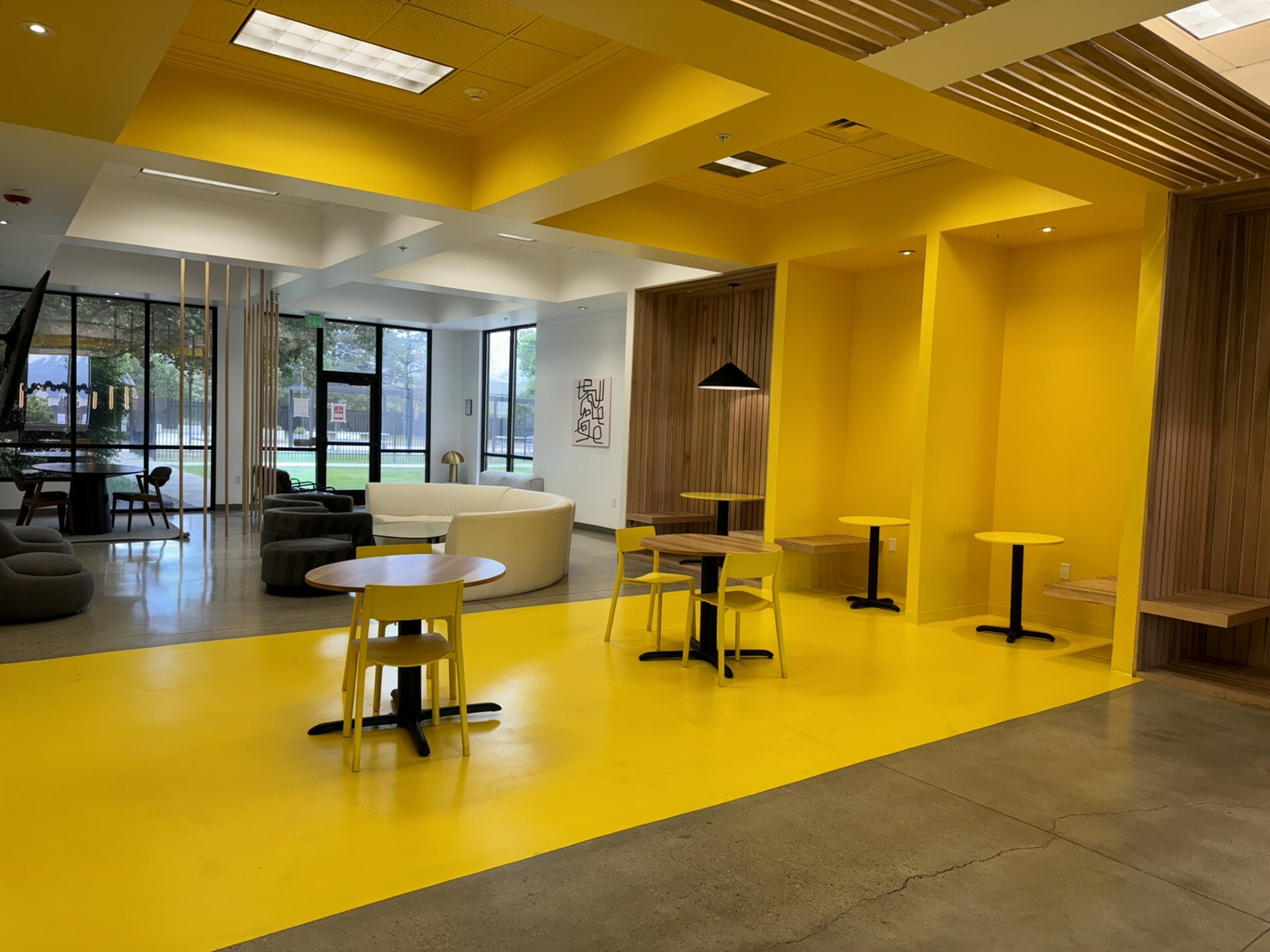 Clubroom at The Oslo with modern seating, large windows, and open gathering space for residents