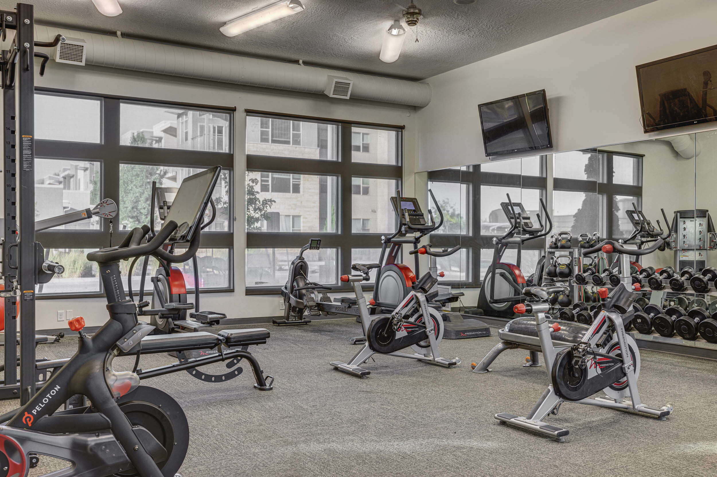 Fully equipped fitness center with Peloton bikes at Eaglewood Lofts