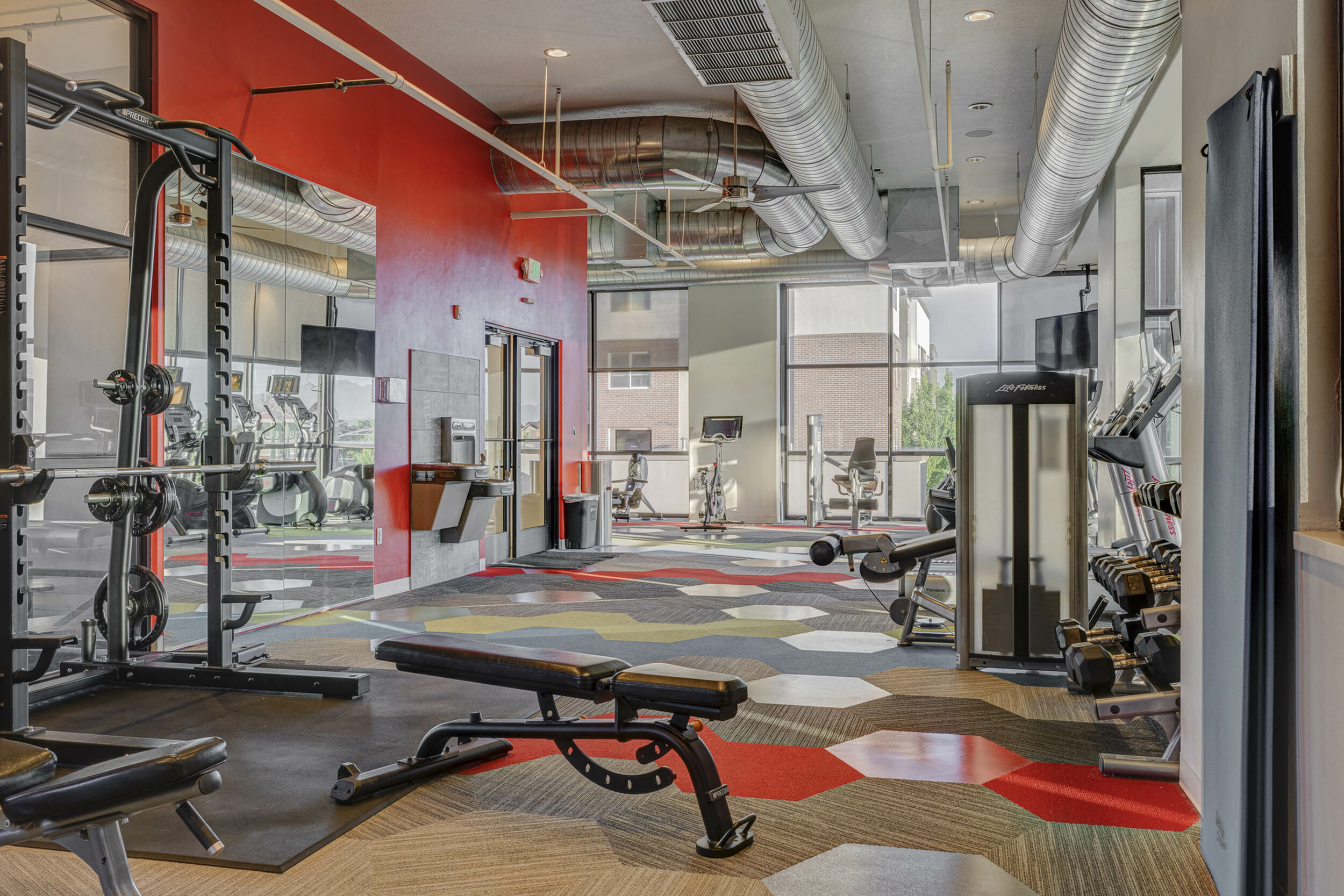 Fitness center at Parkway Lofts in Orem, Utah, featuring top-of-the-line cardio equipment and free weights for a complete workout experience.