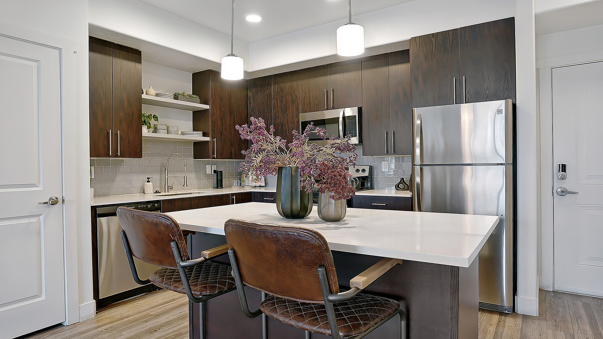 Gourmet kitchen at Parkway Lofts featuring elegant stone countertops, large kitchen island, and modern finishes designed for both functionality and style.