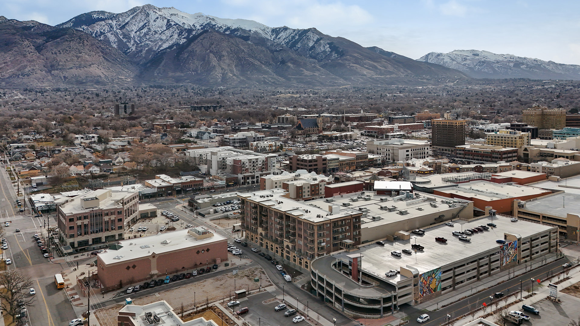 Aerial view of Junction View Apartments in downtown Ogden, Utah with surrounding city and Wasatch Mountain views.