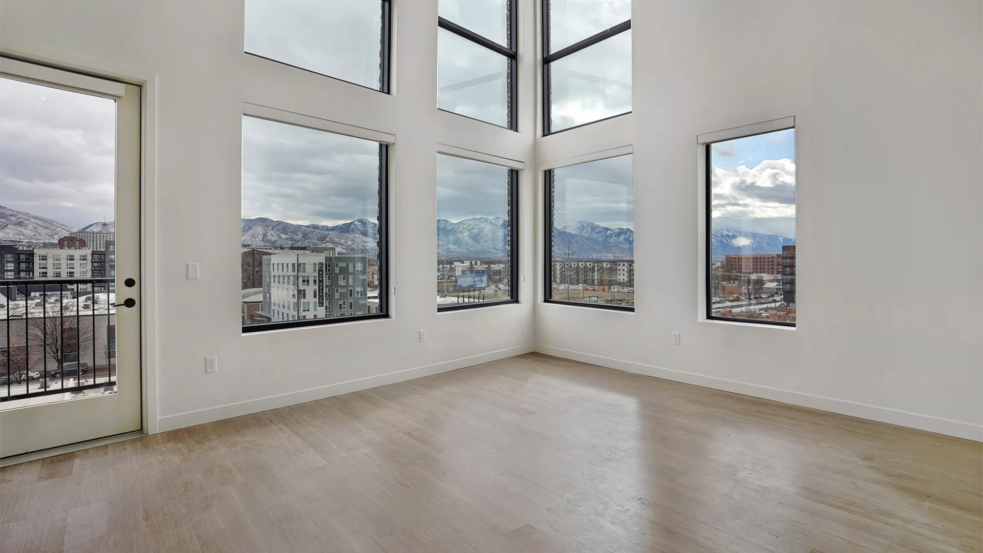 Sixth-floor penthouse at Greenside at Silo Park with vaulted ceilings, expansive windows, and mountain views.
