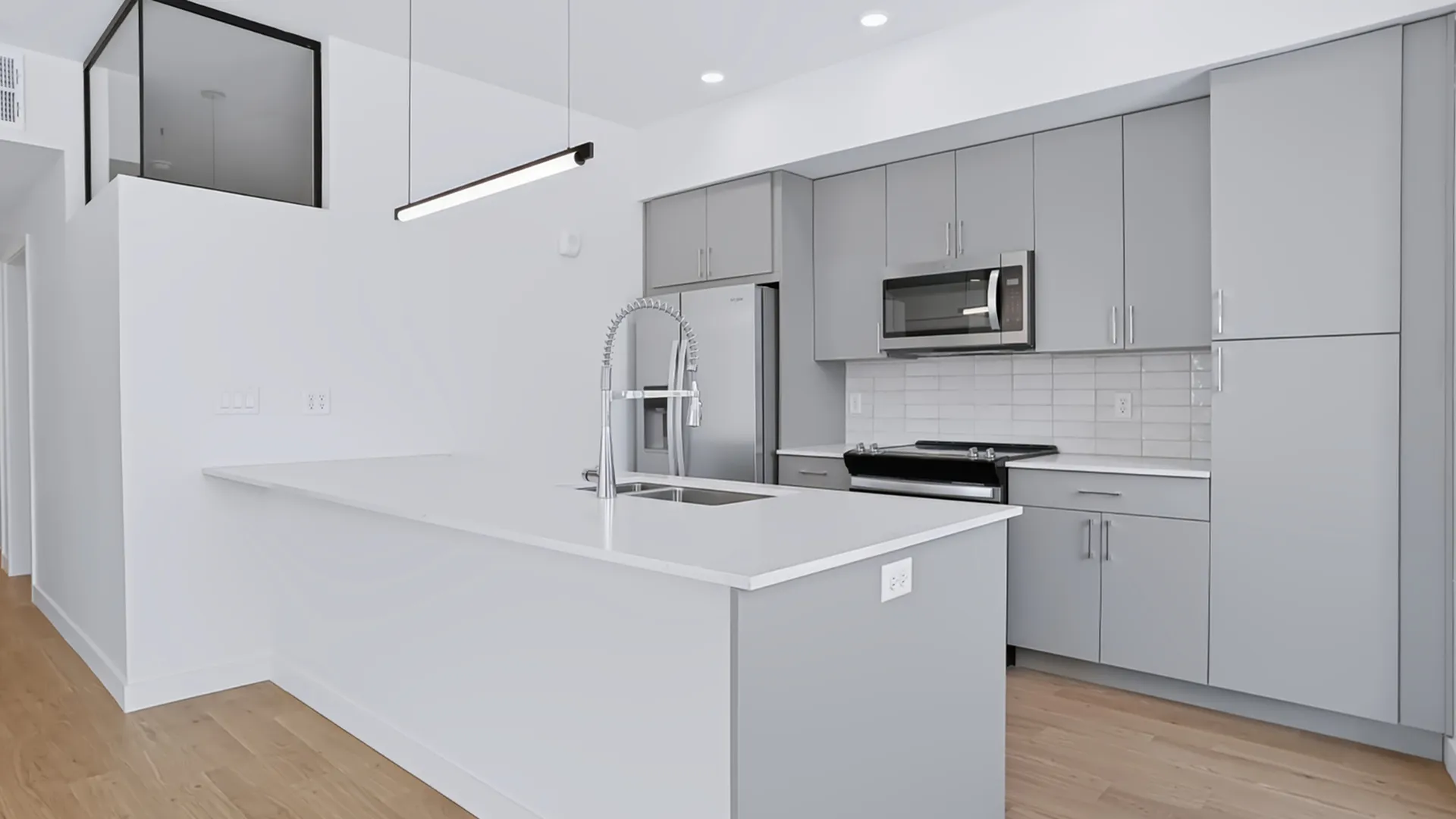 Modern kitchen at Greenside at Silo Park with a large island, contemporary cabinetry, and stainless steel appliances.
