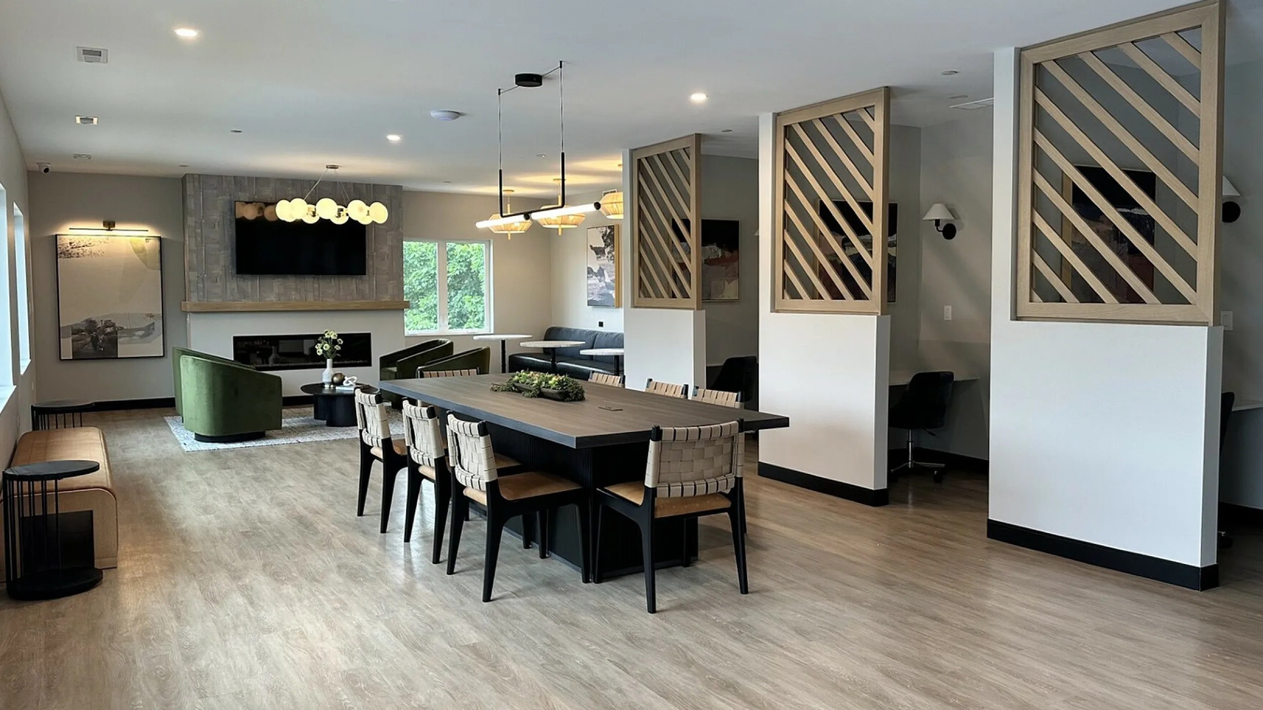 Chic and modern communal area with stylish dining setup, cozy seating, and contemporary lighting, perfect for gatherings.