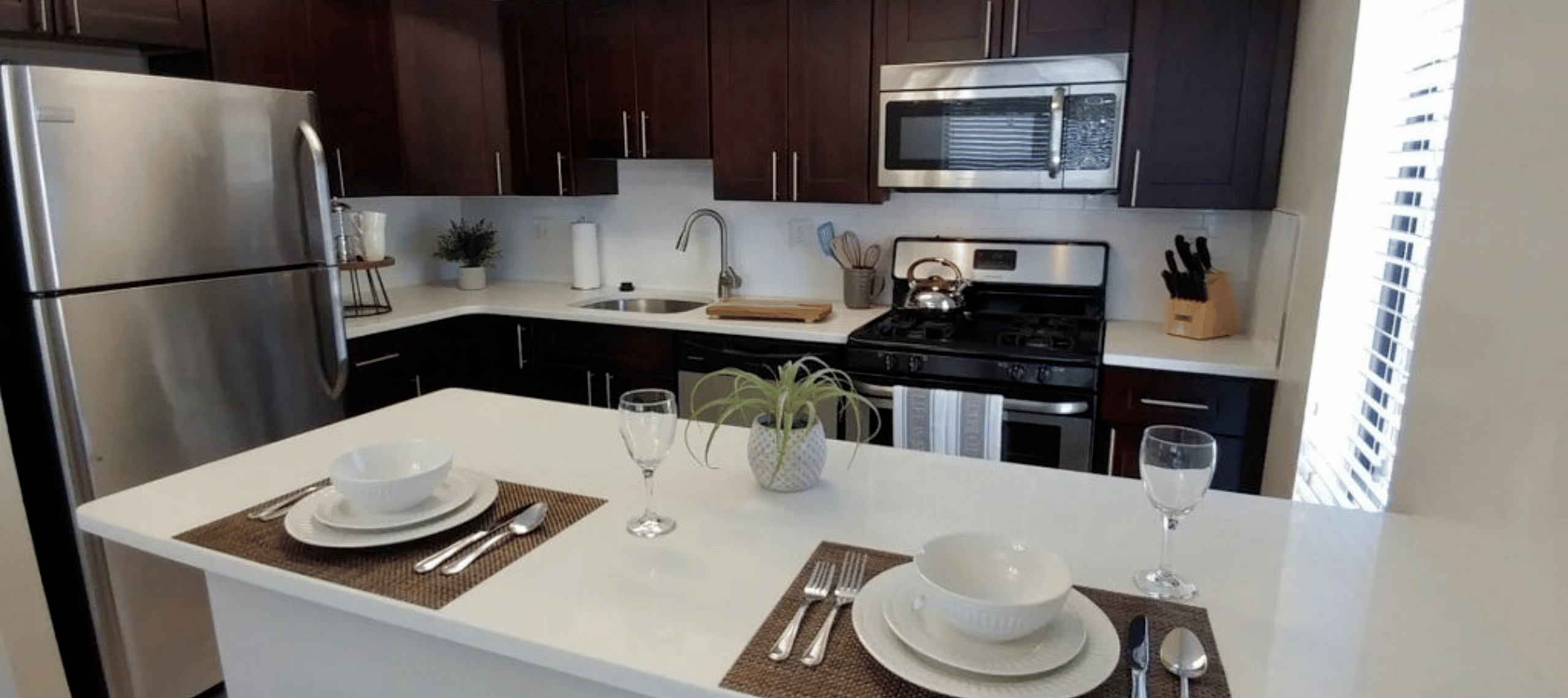 Modern kitchen with updated appliances and breakfast bar at Summit Park