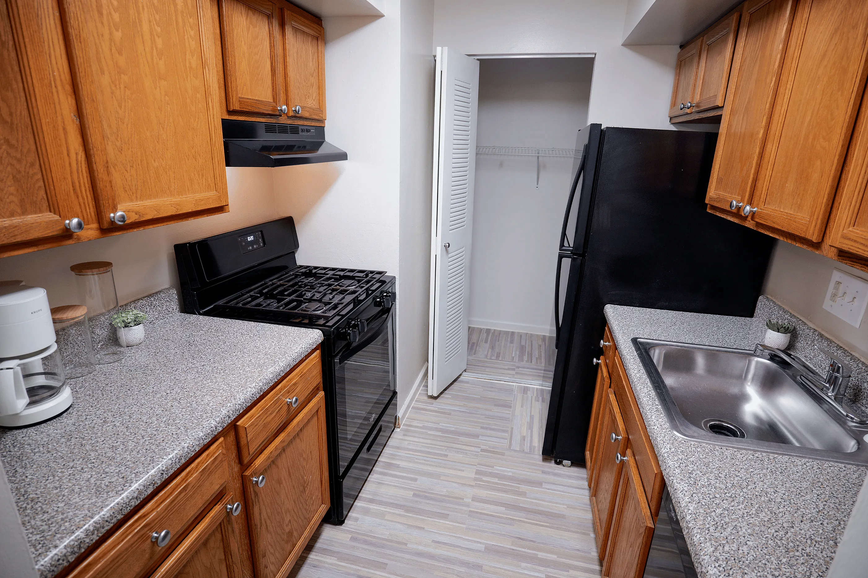 Spacious kitchen with ample pantry storage at Woodmere Apartments