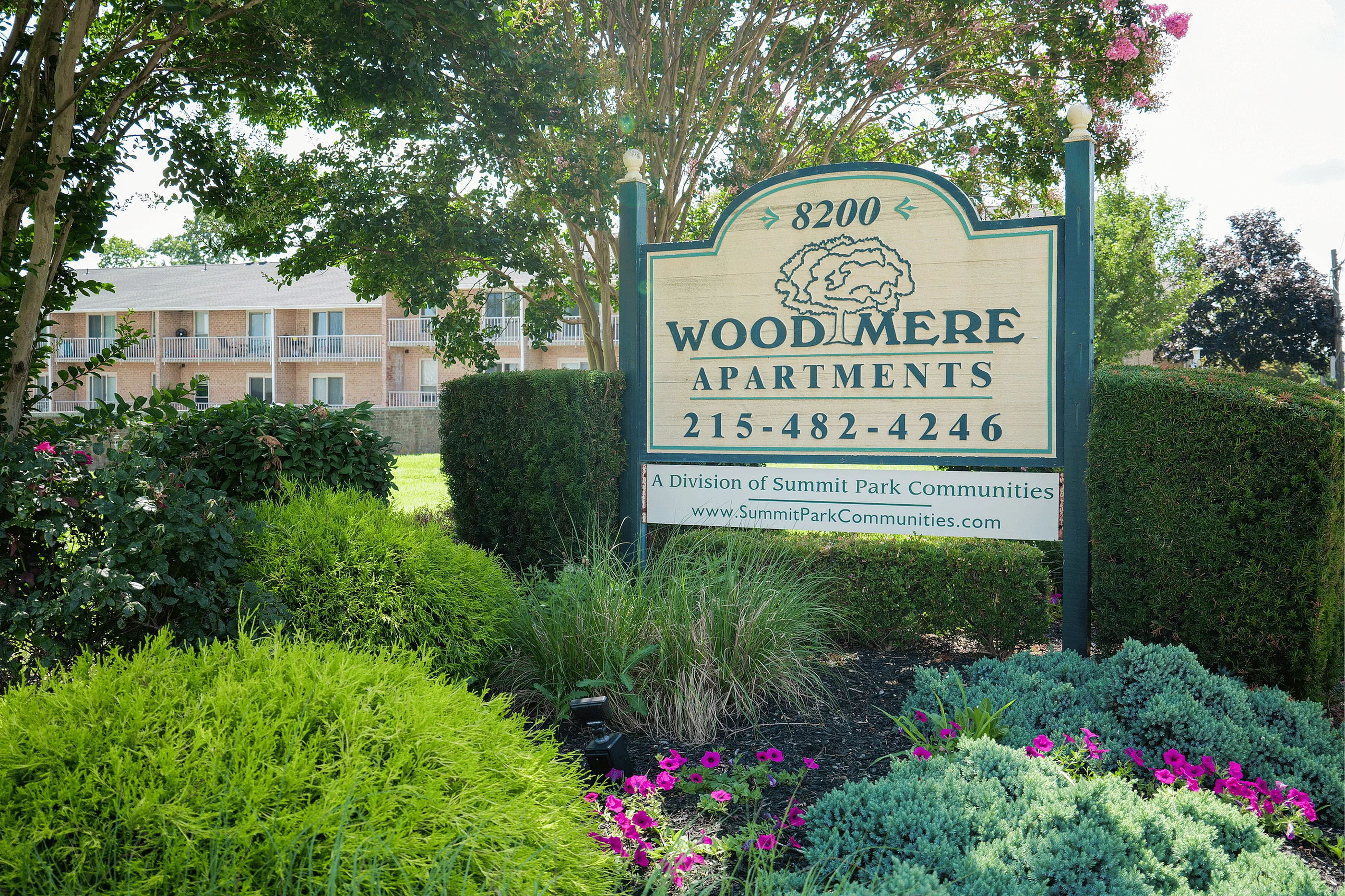 Outdoor entrance sign for Woodmere Apartments in Roxborough