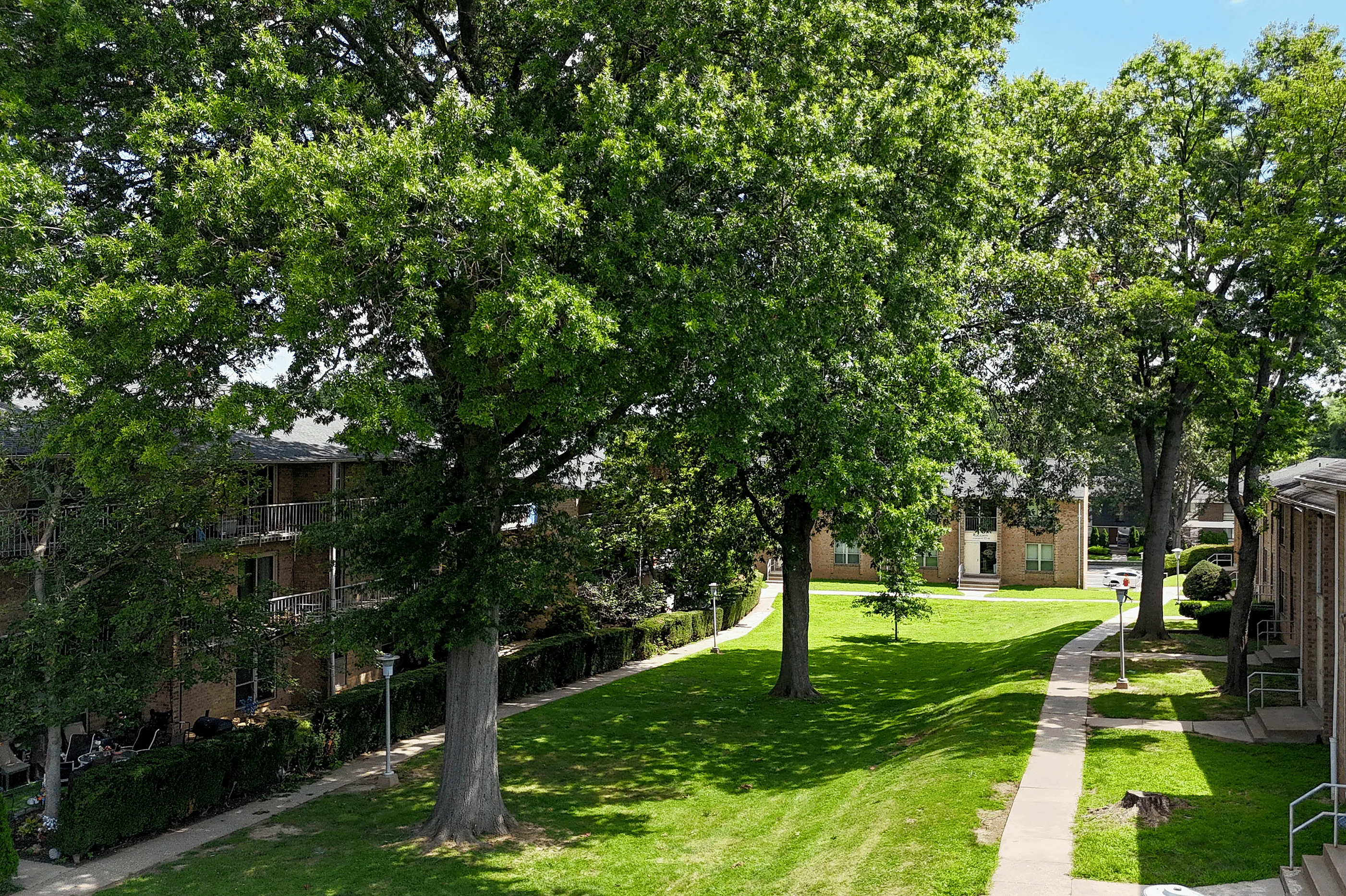Spacious balcony at Woodmere Apartments with seating are