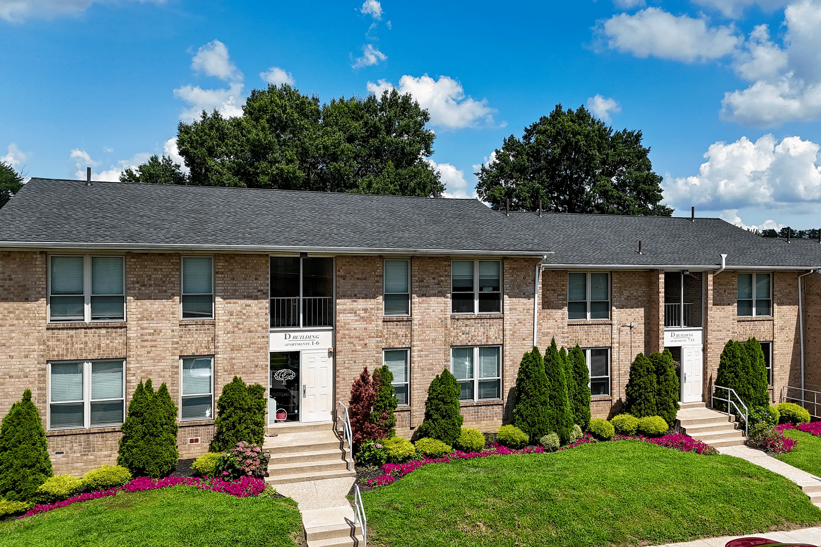 Lush green lawns and gardens at Woodmere Apartments