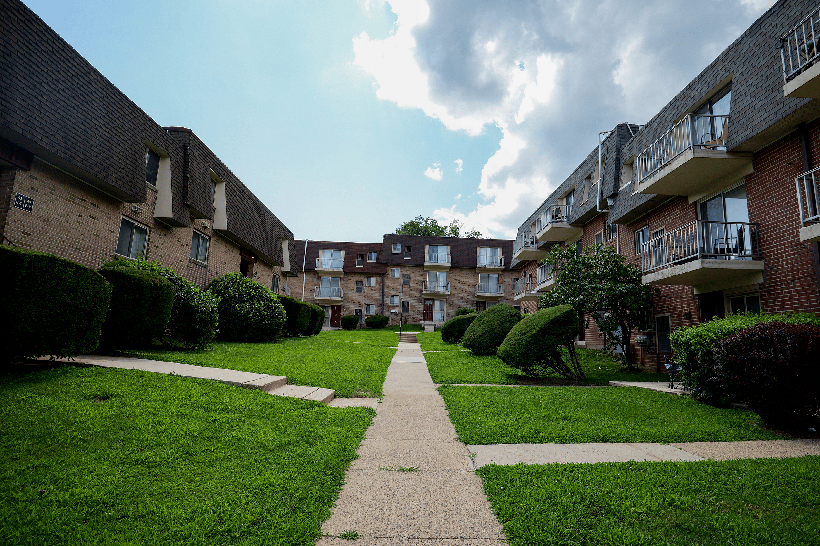 Front view of Valley High Apartments showing private entrances and scenic landscaping